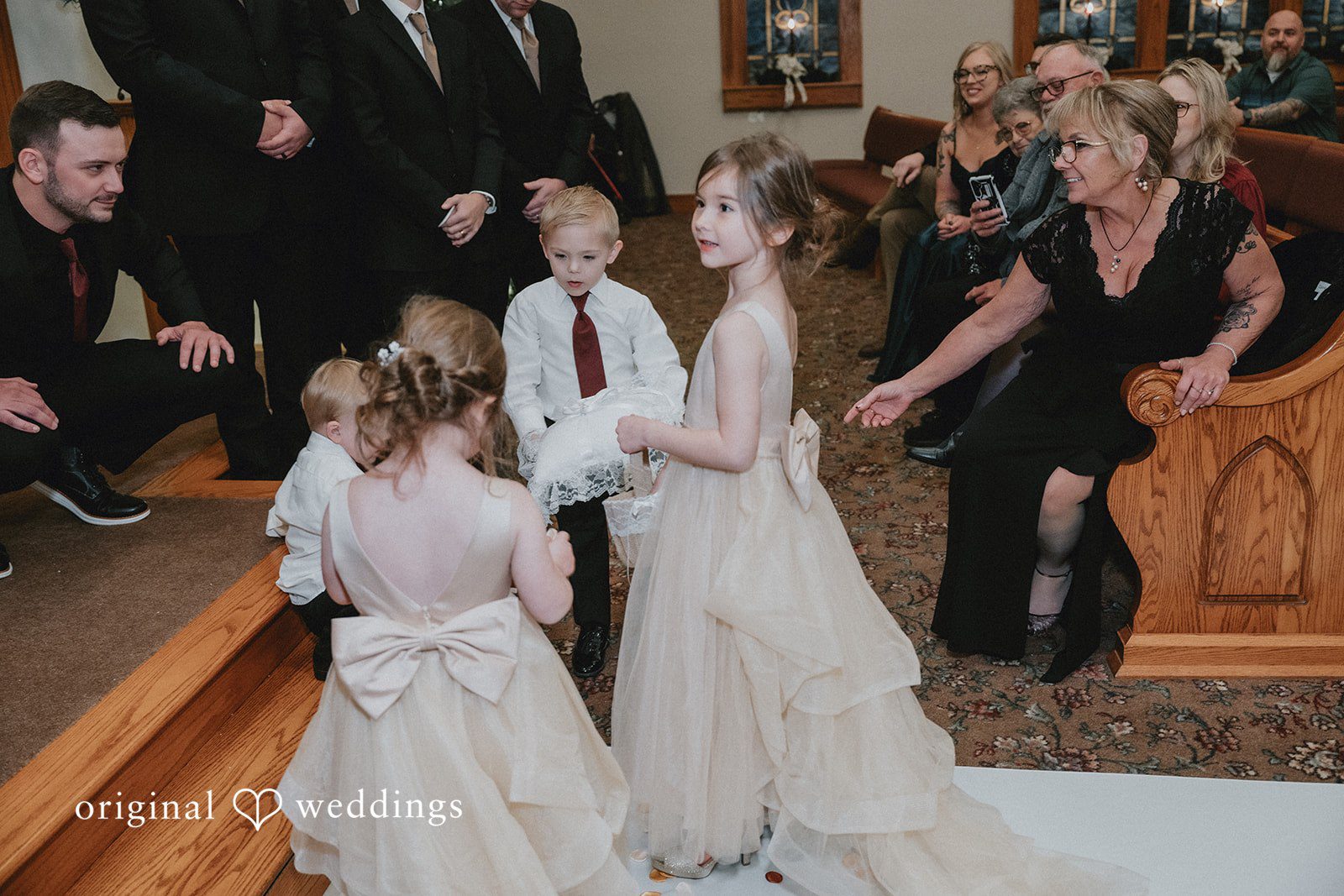 Sarah + Justin Guests look on as people move down the church aisle before the ceremony.