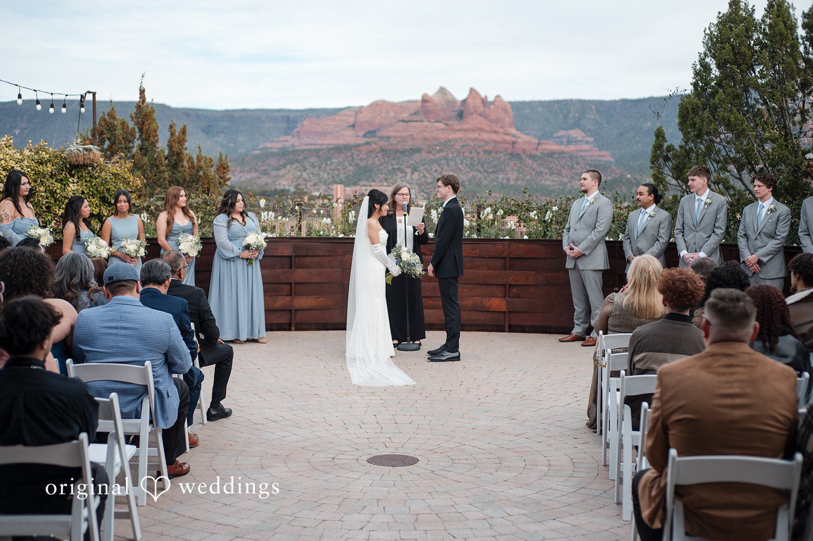 Phoenix Wedding Photographers capturing bride and groom standing before priest at Agave of Sedona by Original Weddings