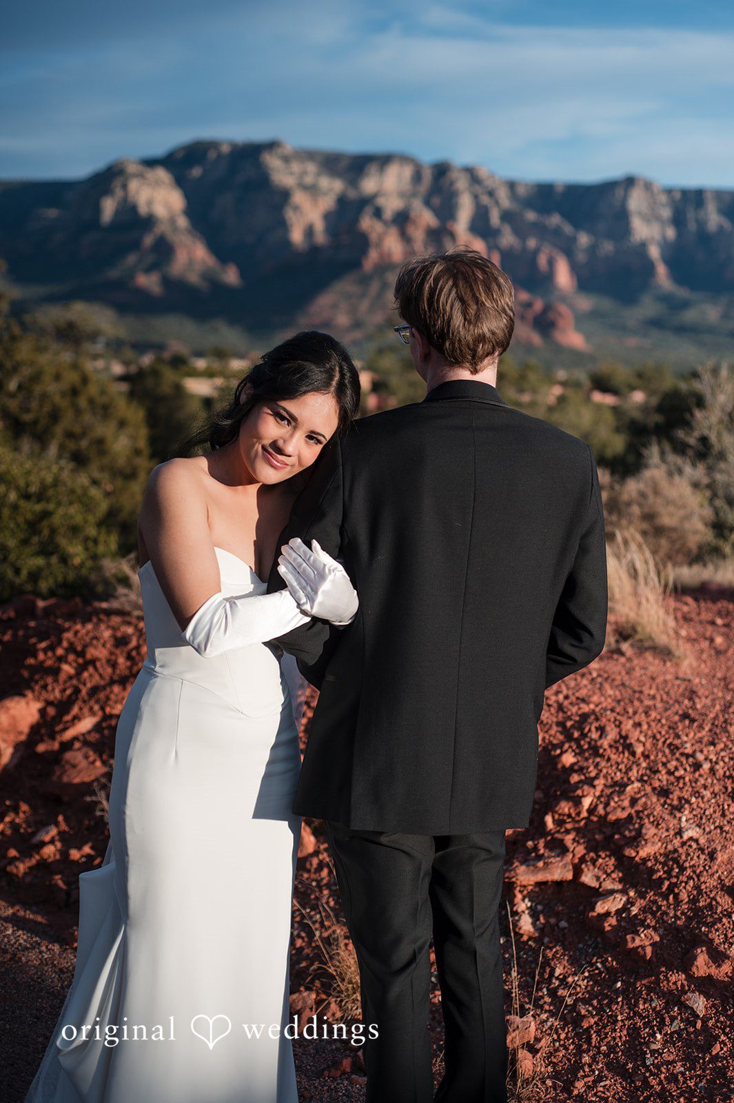 Romantic back hug between bride and groom