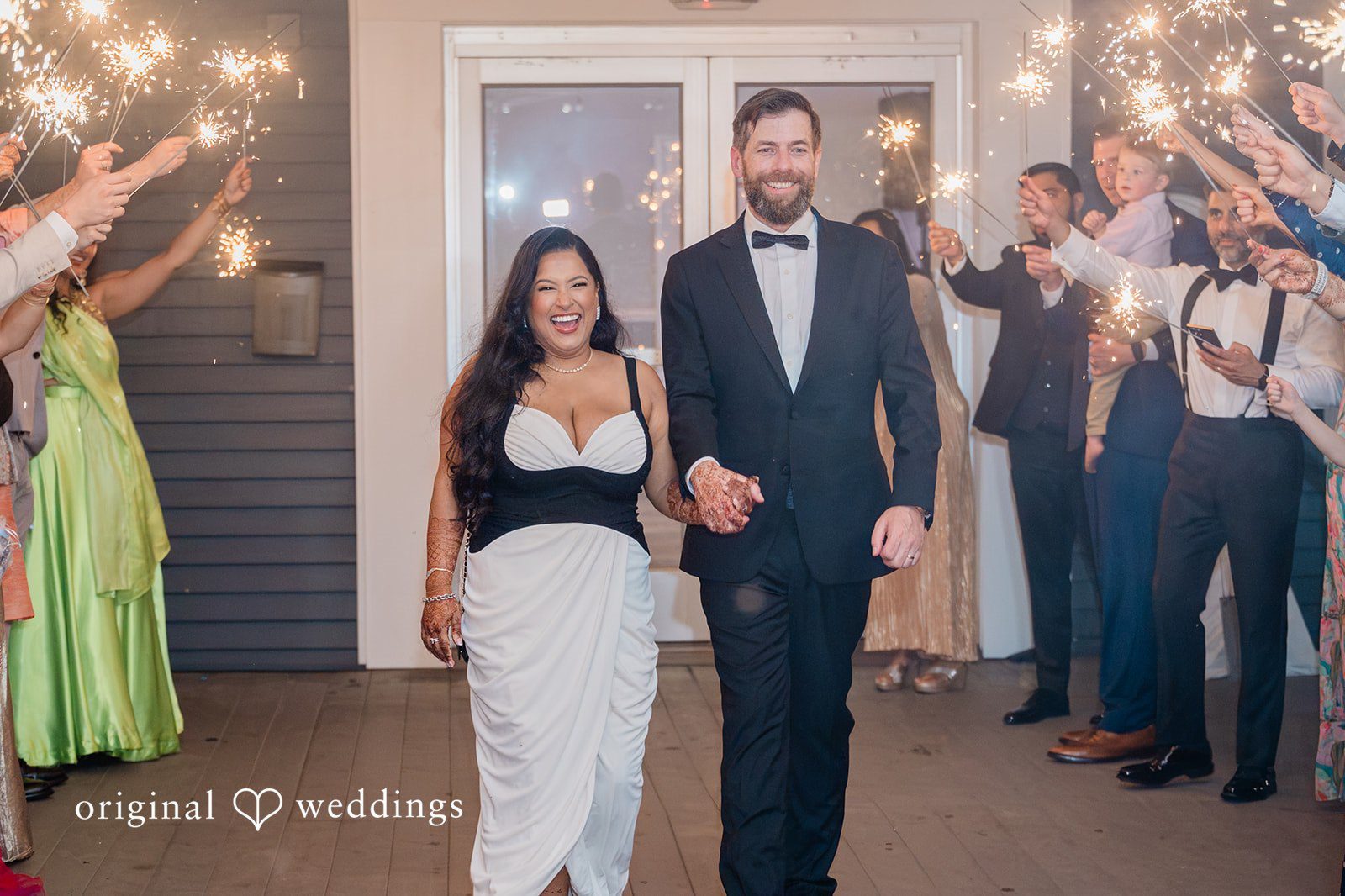 Couple walking through the guests, all cheering around