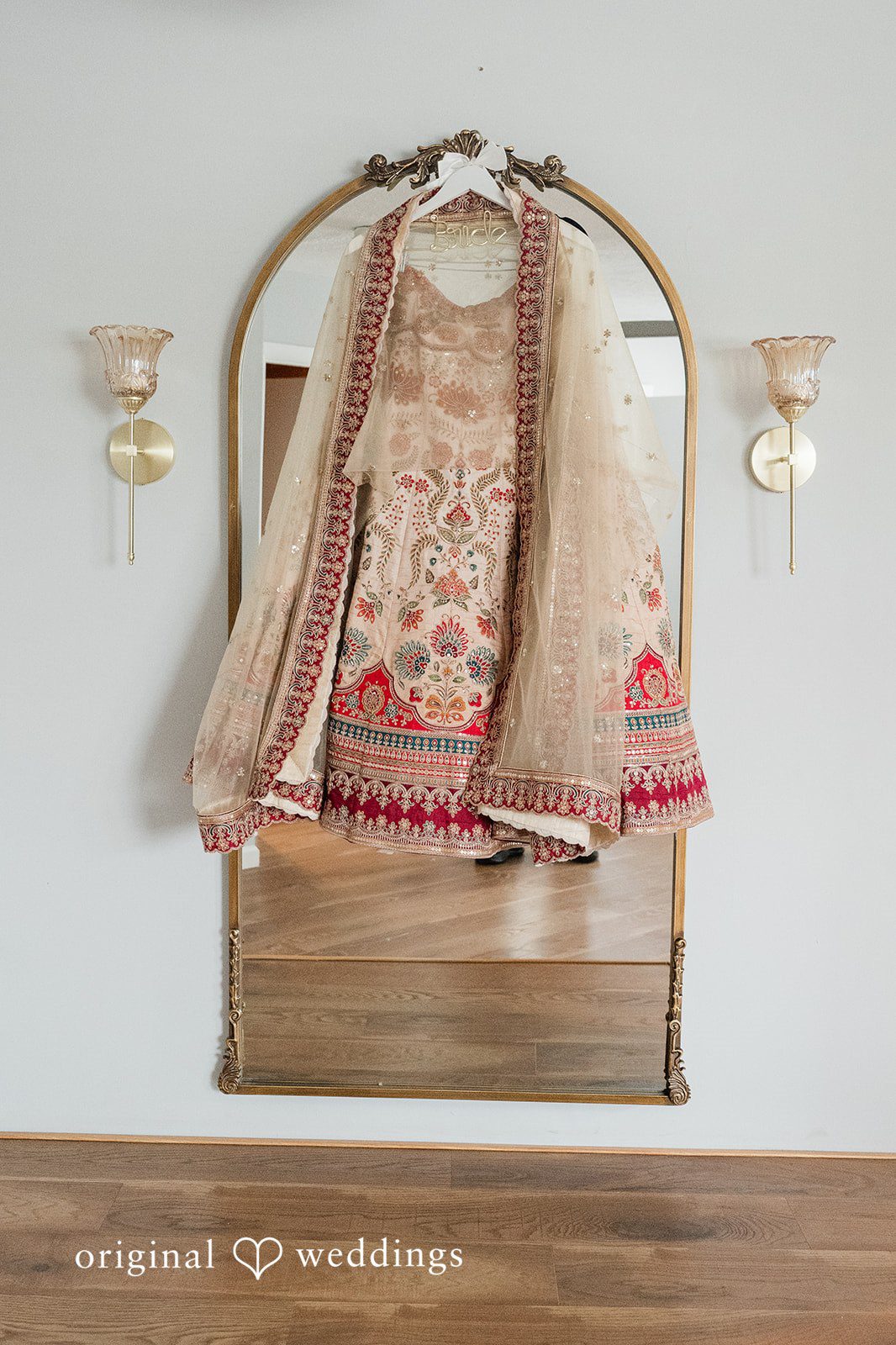 Beautiful wedding dress of bride hang across a mirror