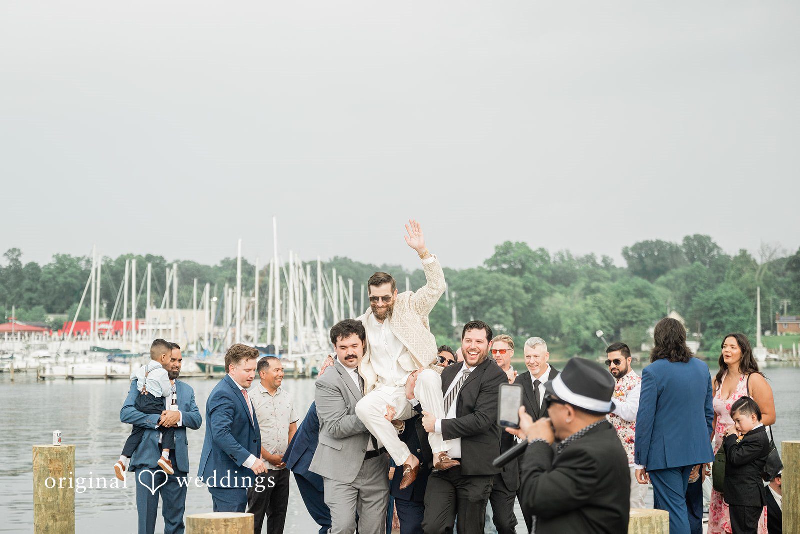 Groom having a fun moment with friends and family