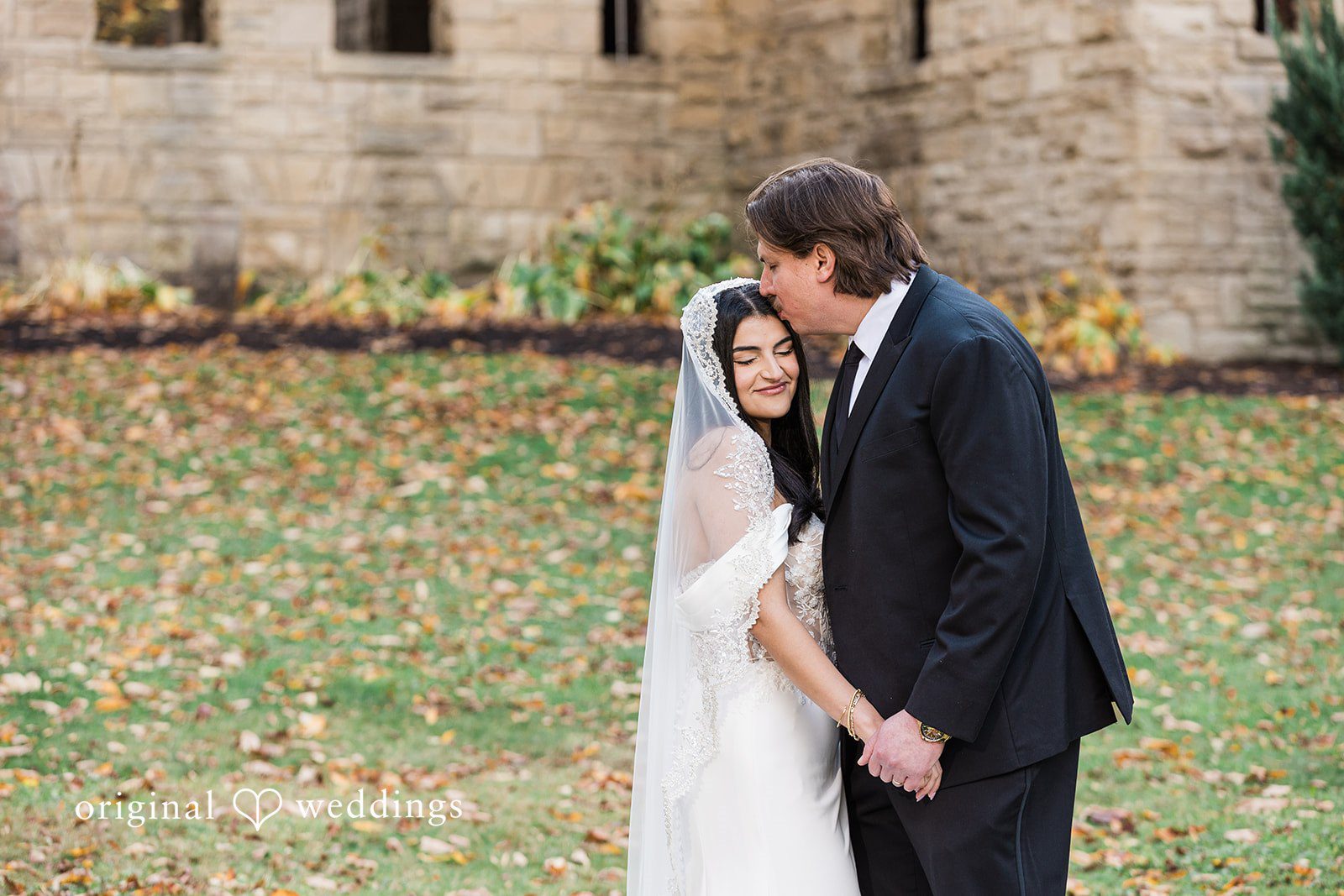 Zaina + Nick Cleveland Wedding Photographers capturing couple kissing at Annunciation Greek Orthodox Church by Original Weddings