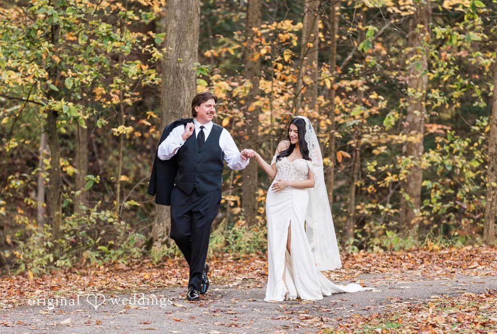 Zaina + Nick Cleveland Wedding Photographers from Original Weddings capturing couple smiling at each other while walking at Annunciation Greek Orthodox Church