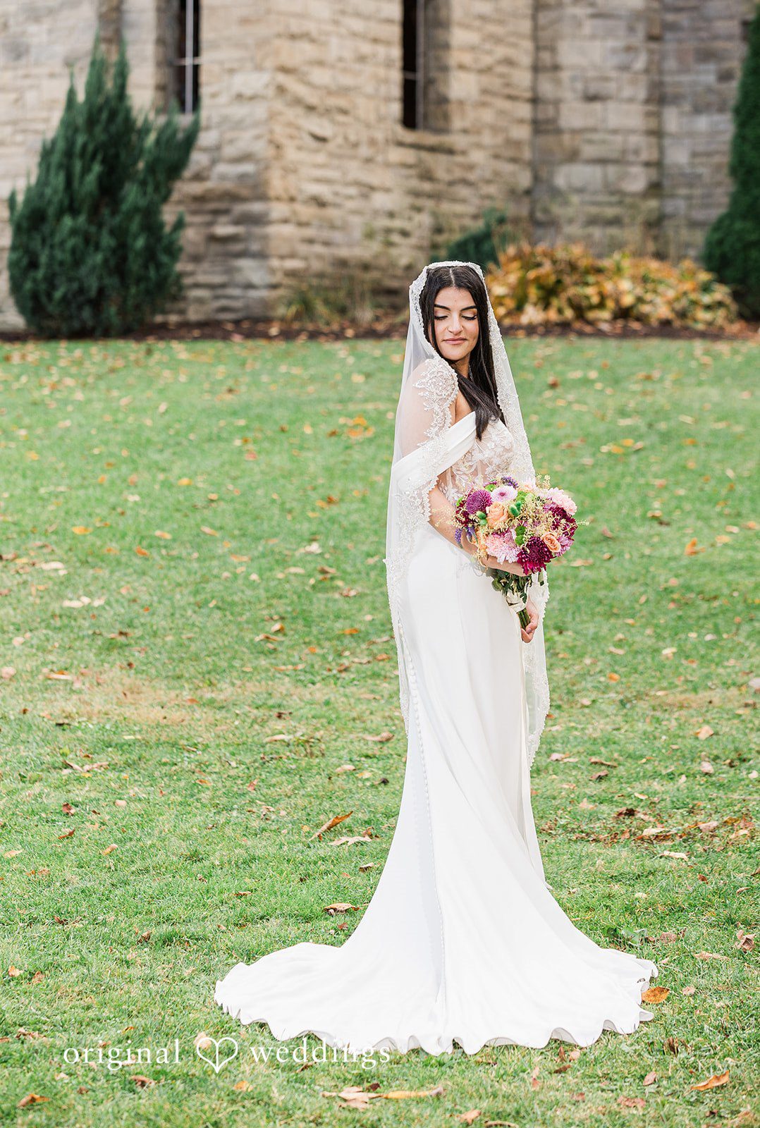 Zaina + Nick Romantic bride solo pose with flowers at Annunciation Greek Orthodox Church