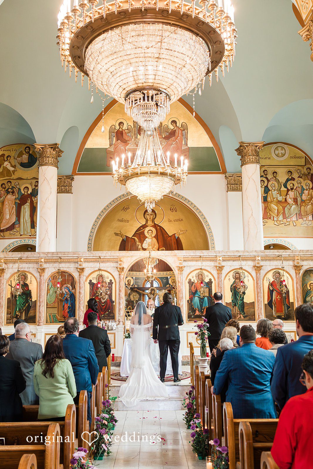 Zaina + Nick Elegant bride and groom standing together from behind at Annunciation Greek Orthodox Church