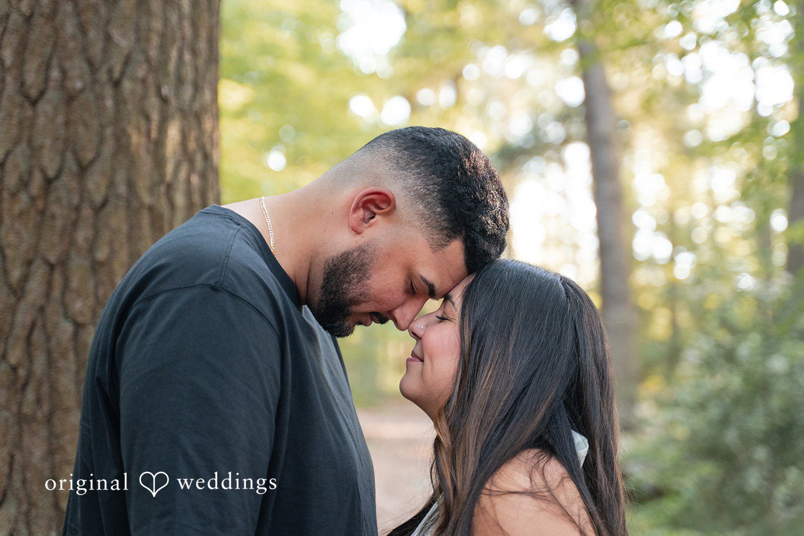 Anya + Max Couple shares a tender forehead touch in a quiet, intimate moment
