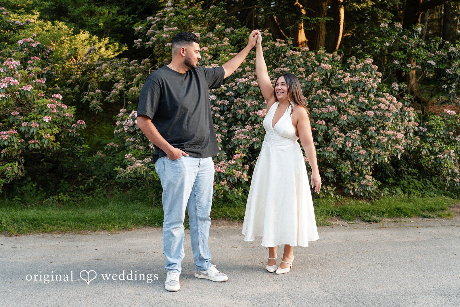 Anya + Max The couple shares a playful twirl surrounded by blooming flowers