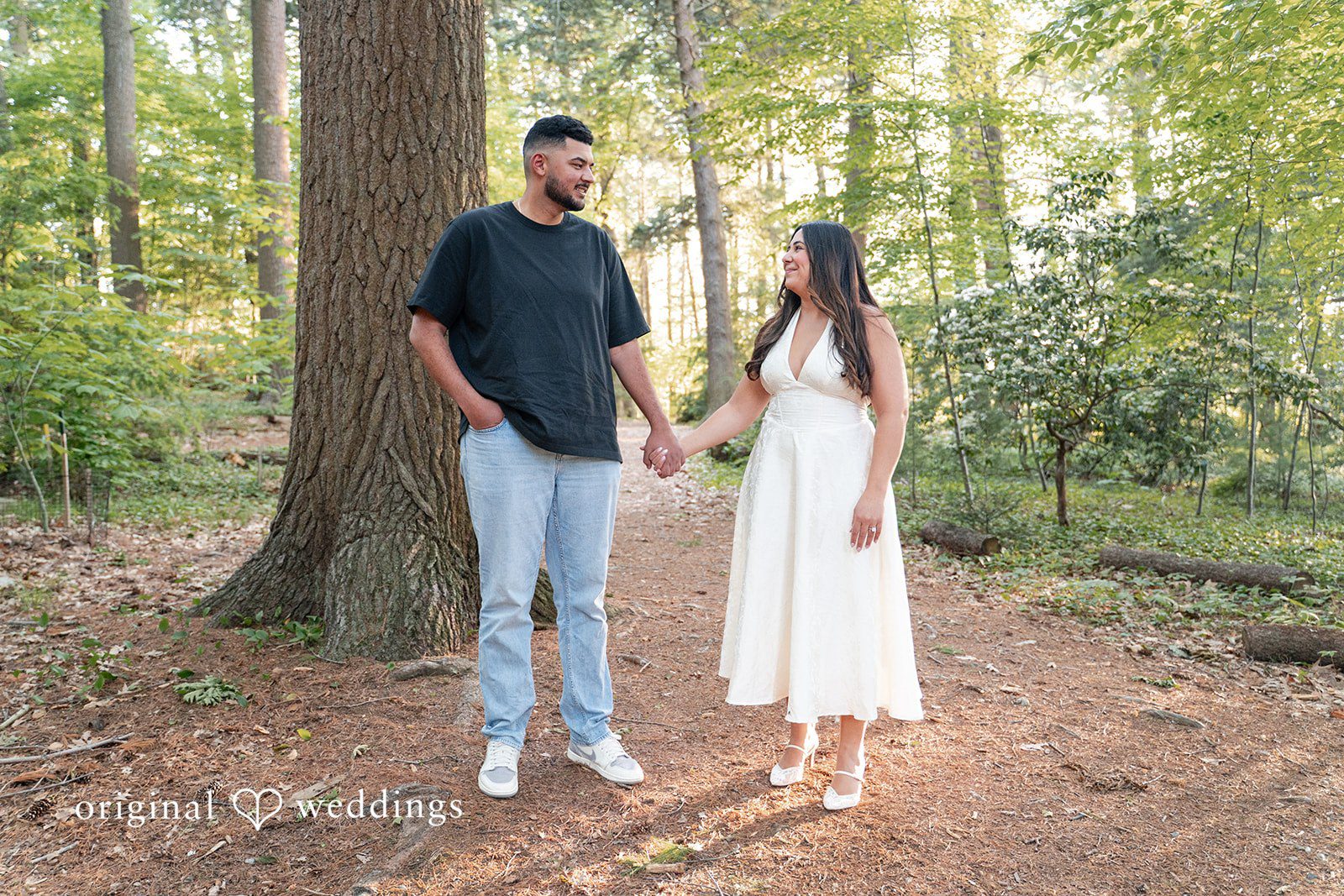 Anya + Max The couple holds hands and smiles at each other