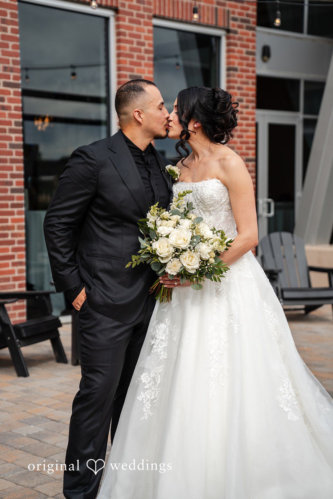 Emily + Miguel The couple shares a kiss