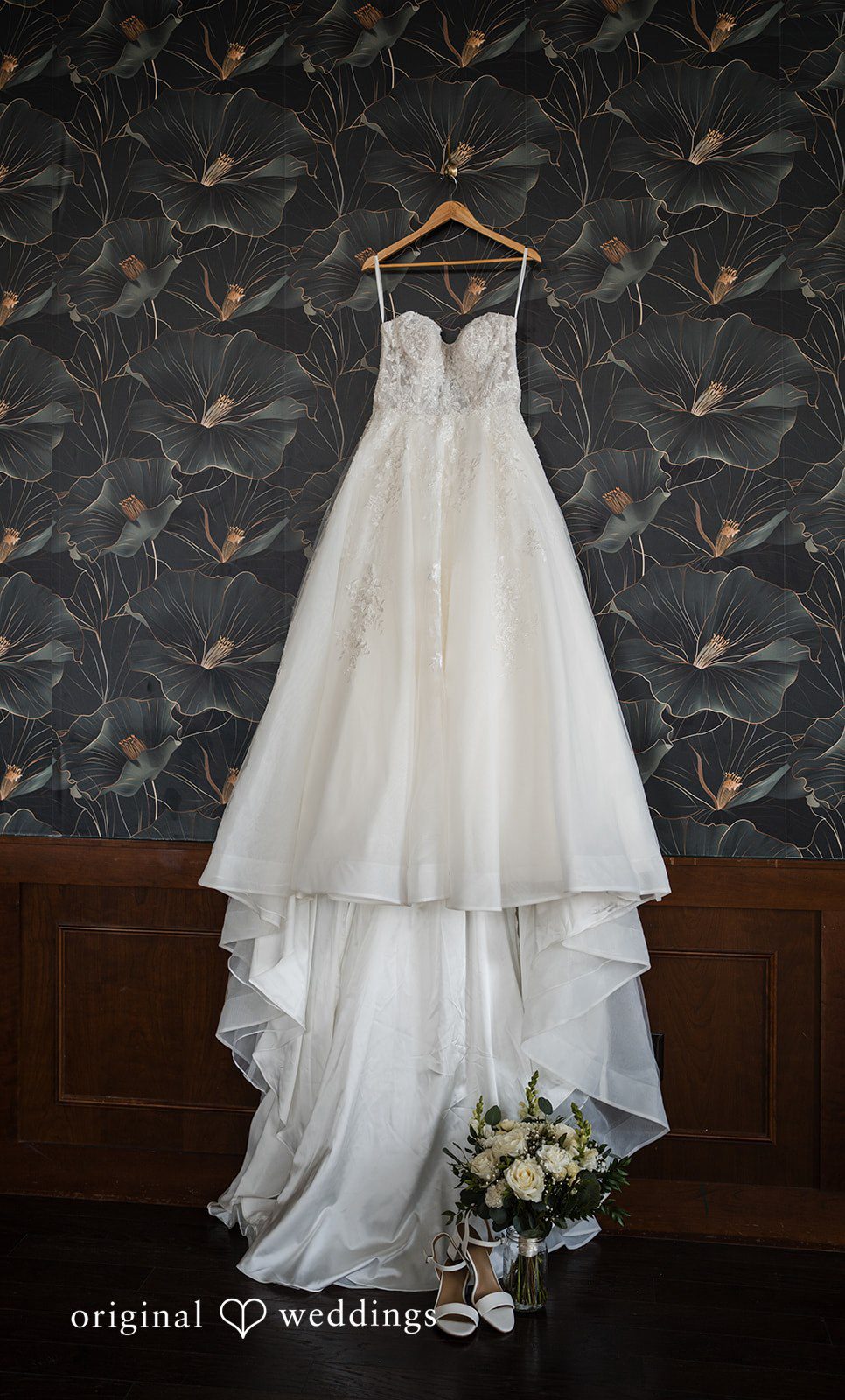 Emily + Miguel The bride's wedding gown gracefully hanging in the suite