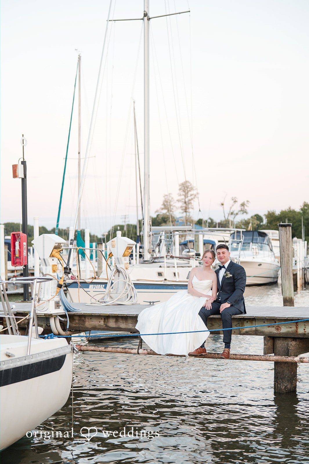 Andrew + Paige Wide waterfront portrait of the newlyweds by the shore