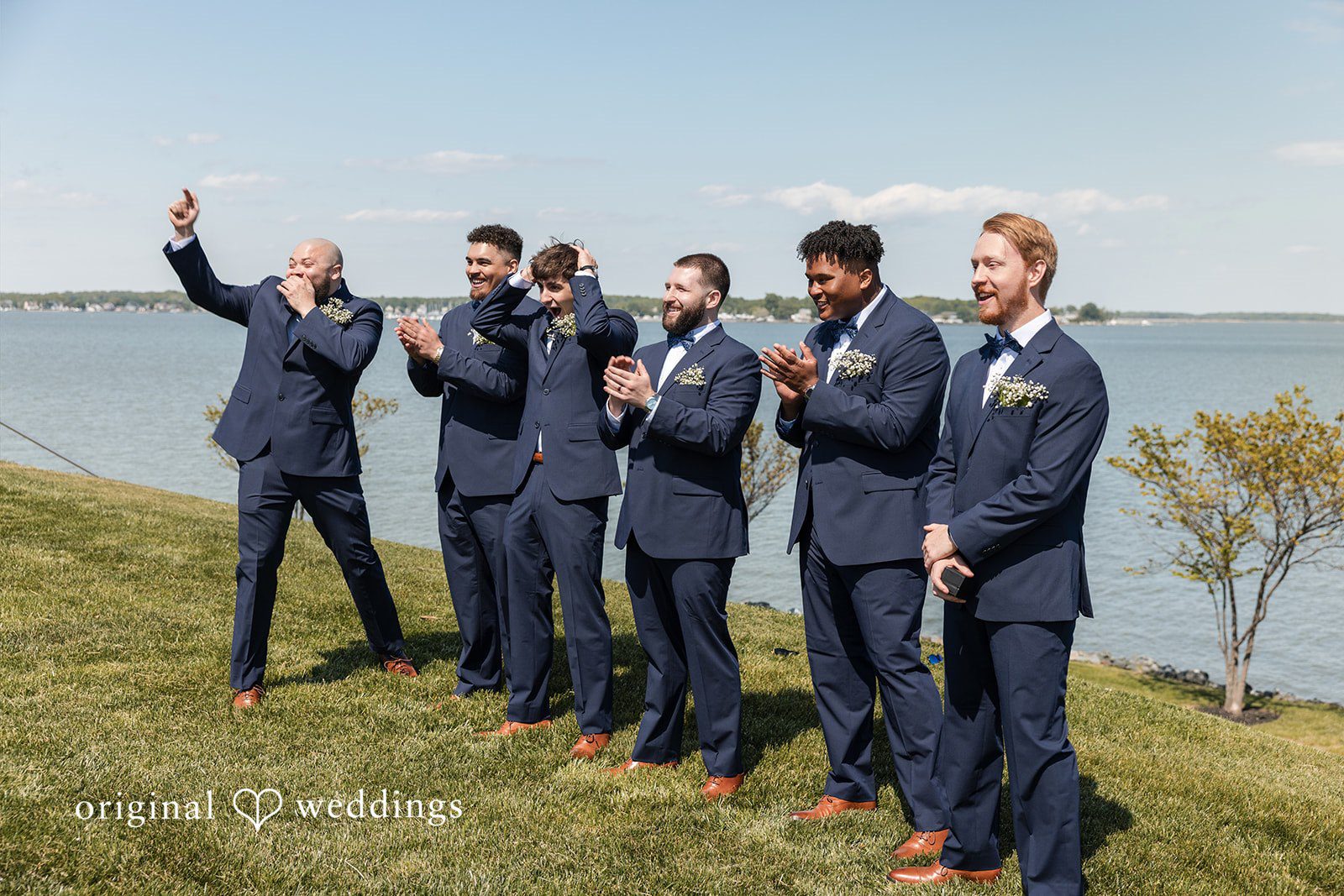 Andrew + Paige Bride and groom with their wedding party by the waterfront