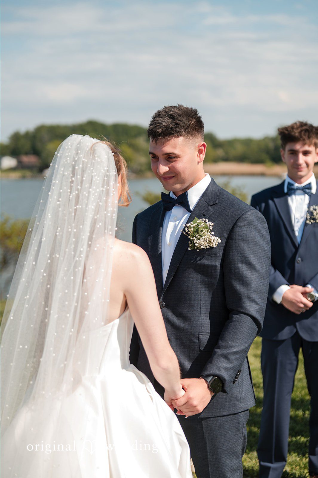 Andrew + Paige Bride and groom holding hands during the ceremony