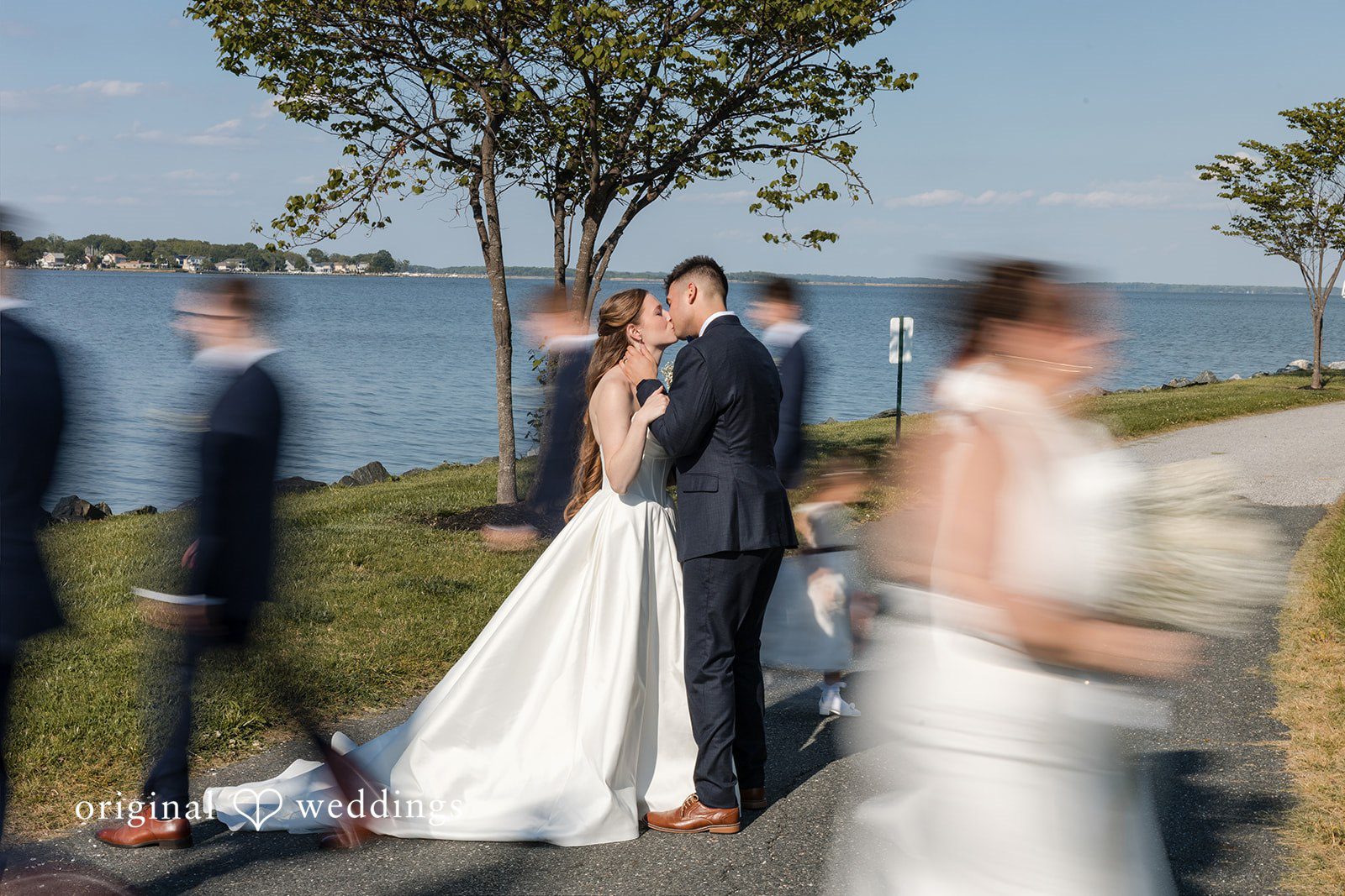 Andrew + Paige Bride and groom sharing a kiss by the waterfront