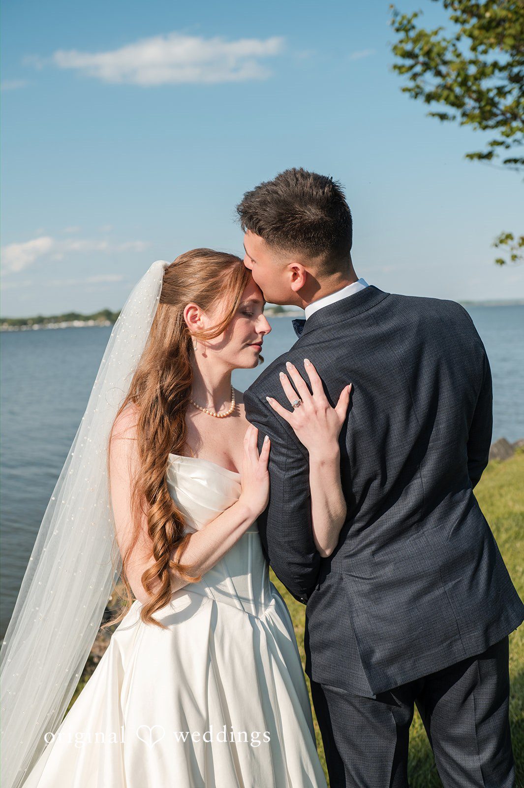 Andrew + Paige Groom kissing the bride on the forehead during portraits