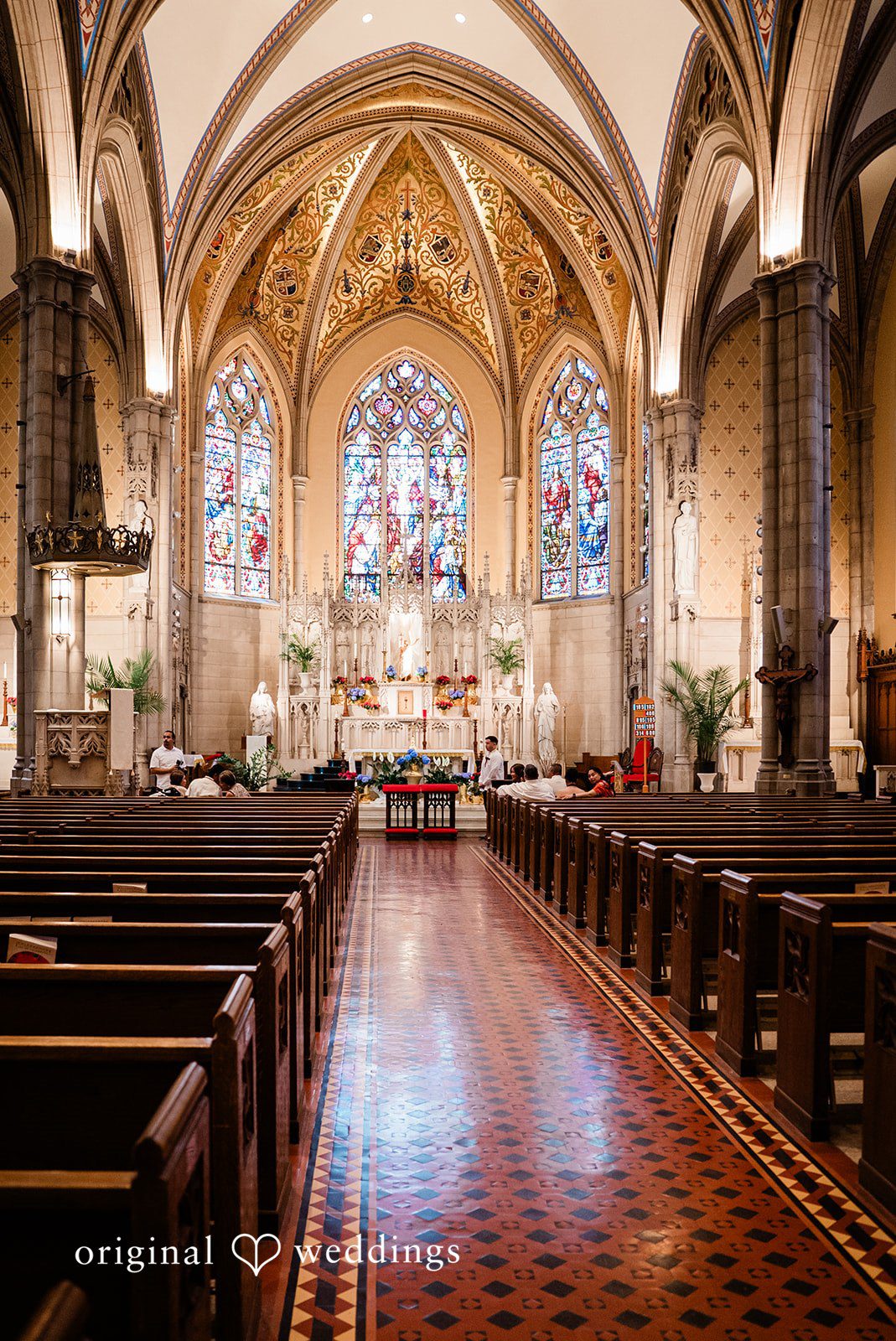 Michael + Maria A stunning church ceremony setup with ornate stained glass and grand architecture