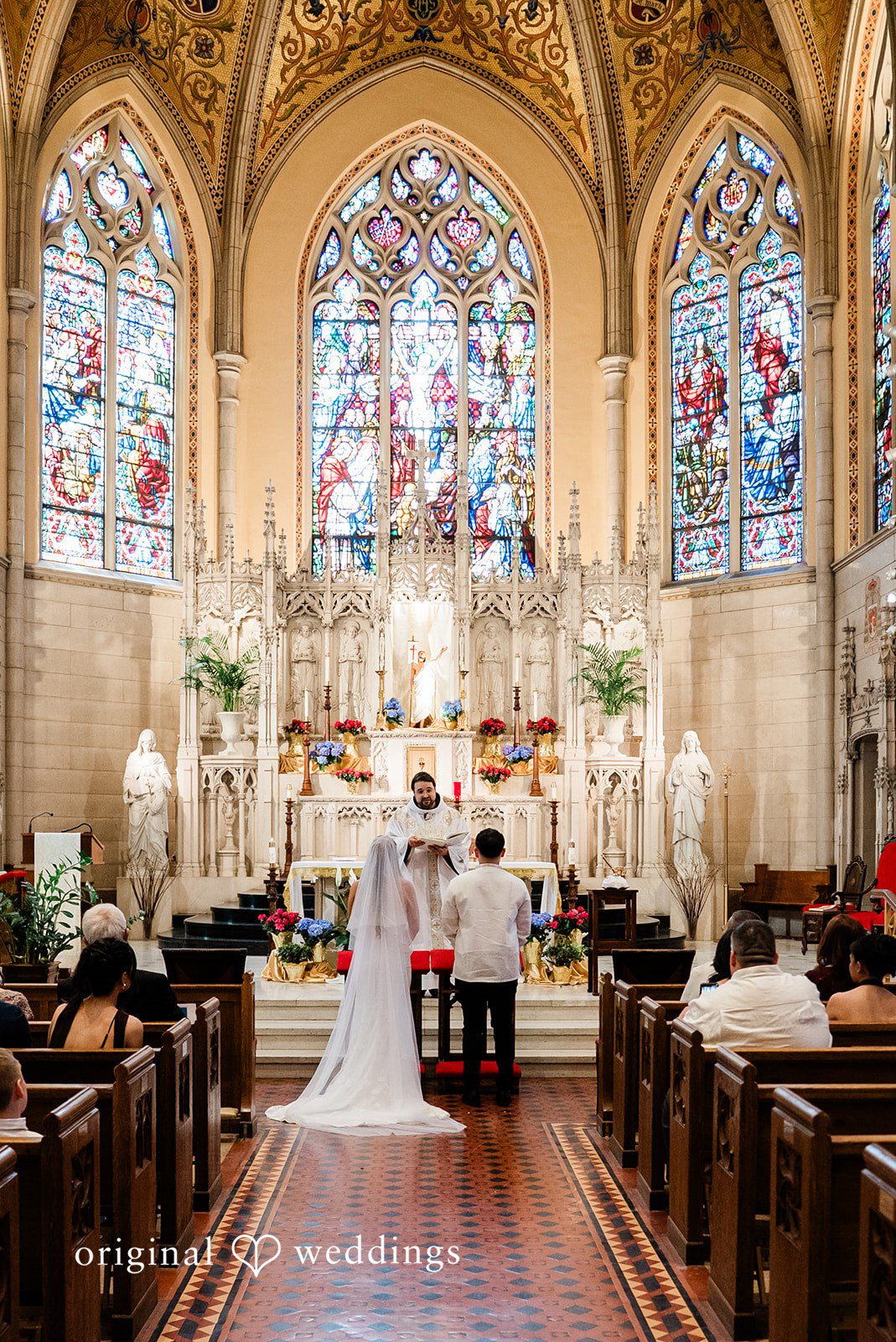 Michael + Maria Bride and groom exchanging vows during a church wedding ceremony before the altar.