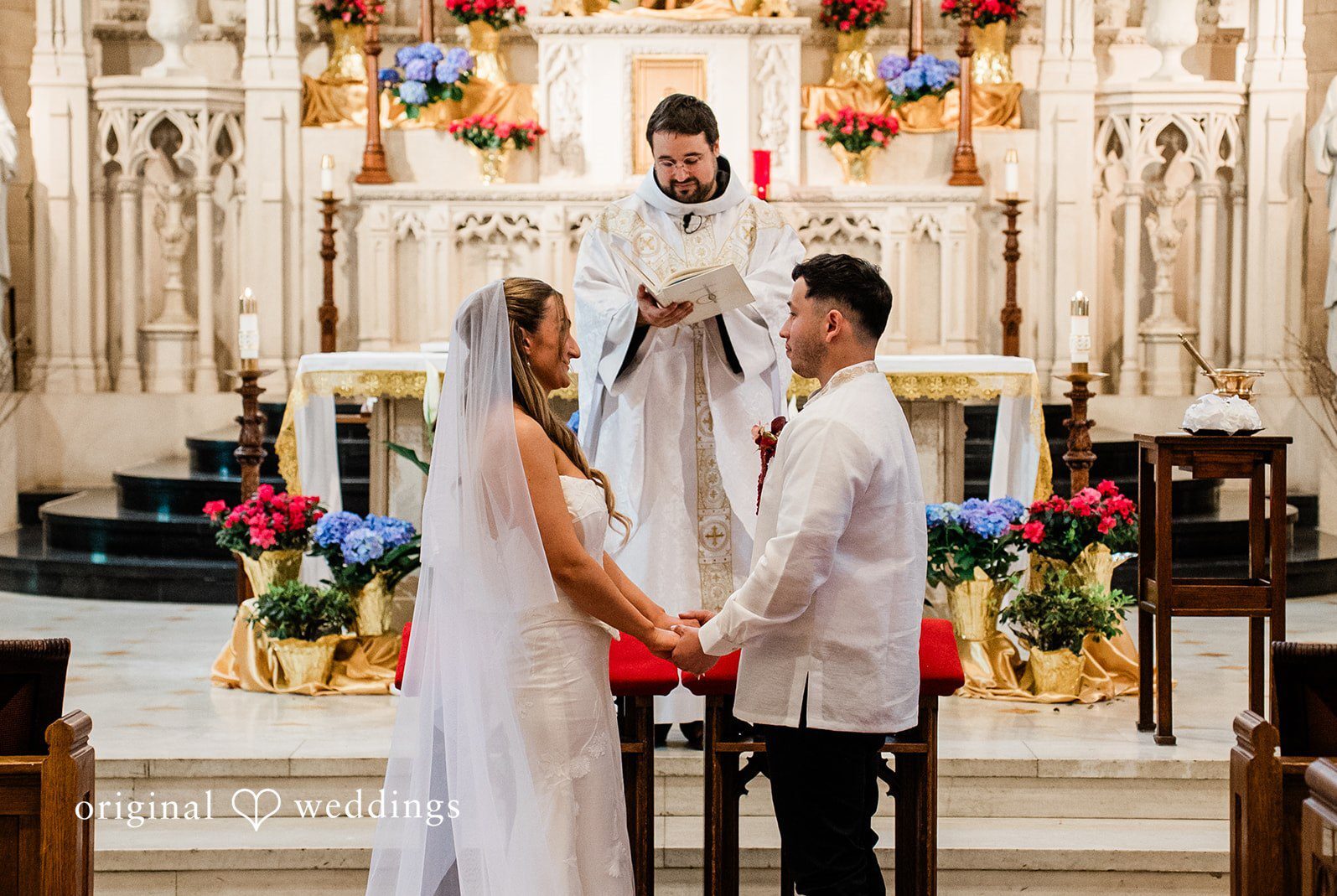 Bride and groom holding hands during their wedding ceremony captured by Chicago wedding photographers from Original Weddings