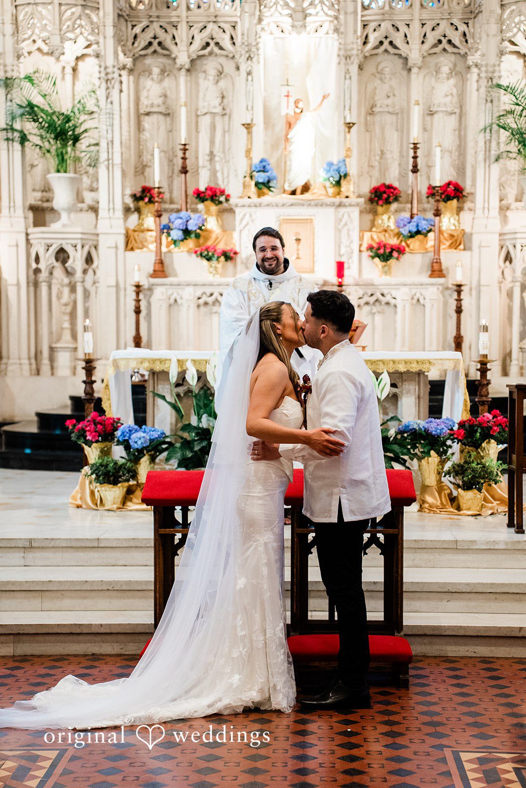 Michael + Maria Bride and groom sharing their first kiss at the altar after exchanging vows.