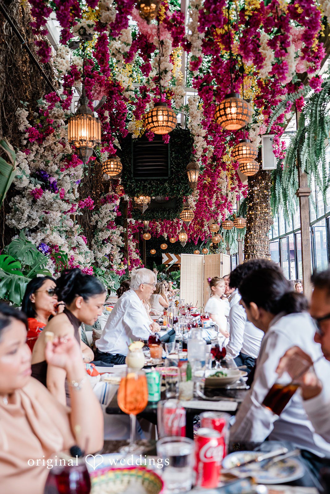 Michael + Maria Reception dinner setup with lush floral ceiling décor at Beatnik on the River.