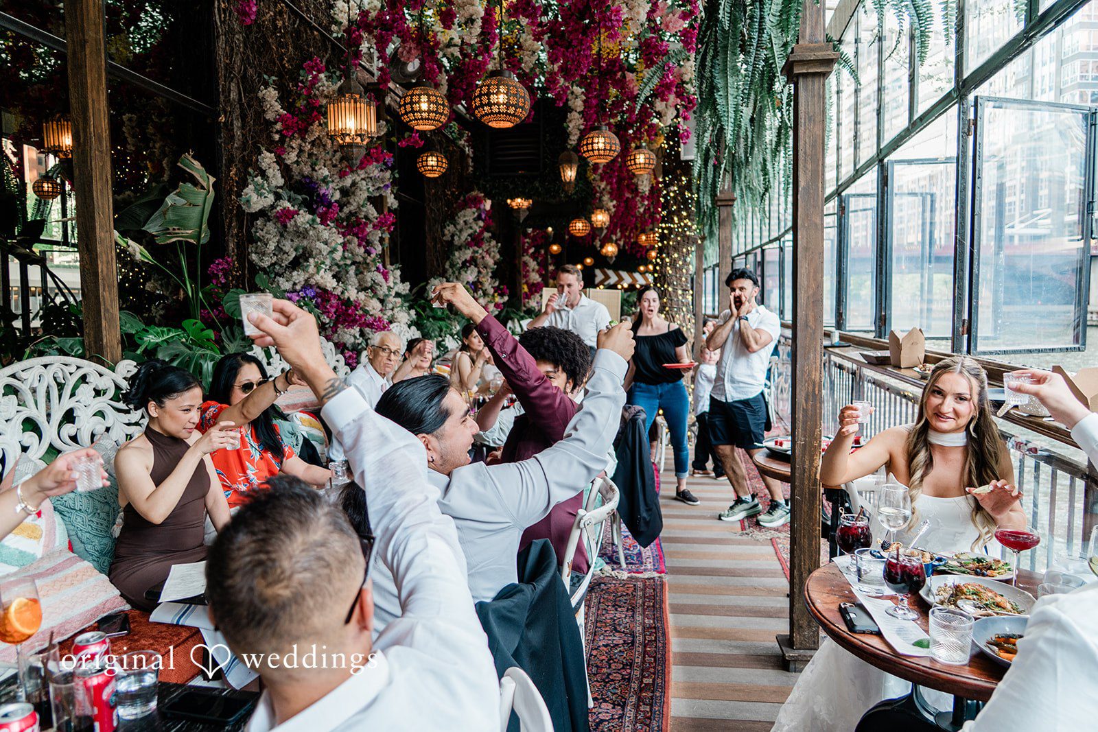 Michael + Maria Guests raising a celebratory toast during the wedding reception at Beatnik on the River.
