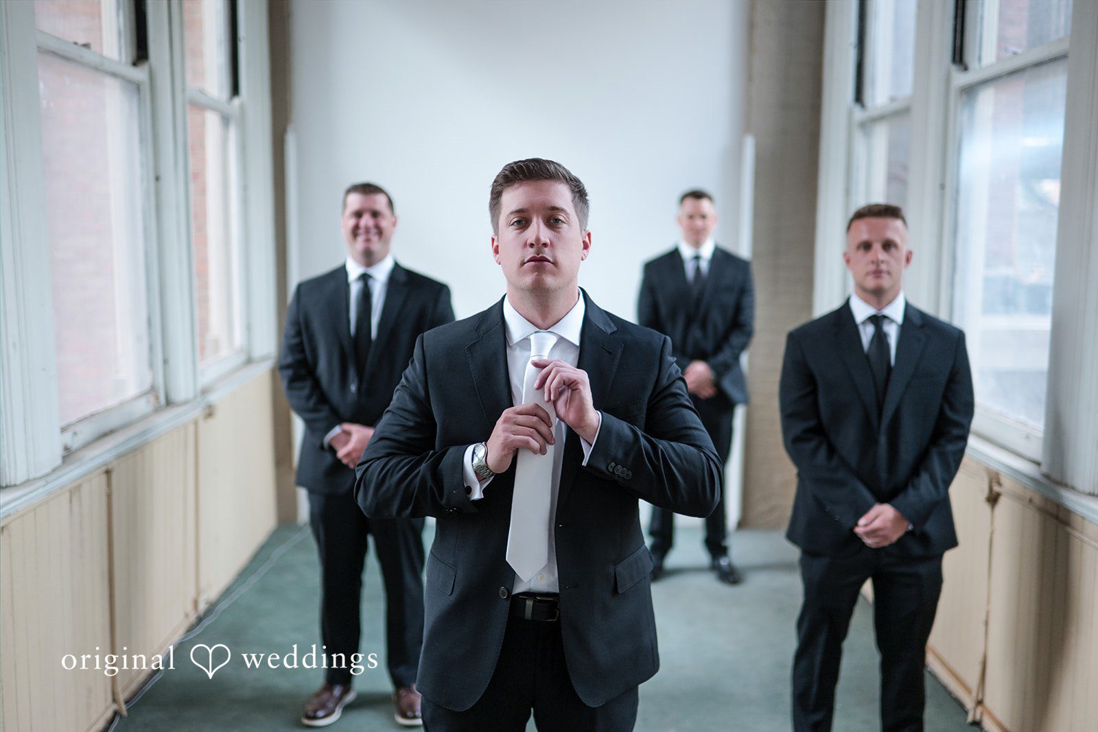 Sydney + Ty Groom posing with his groomsmen before the ceremony