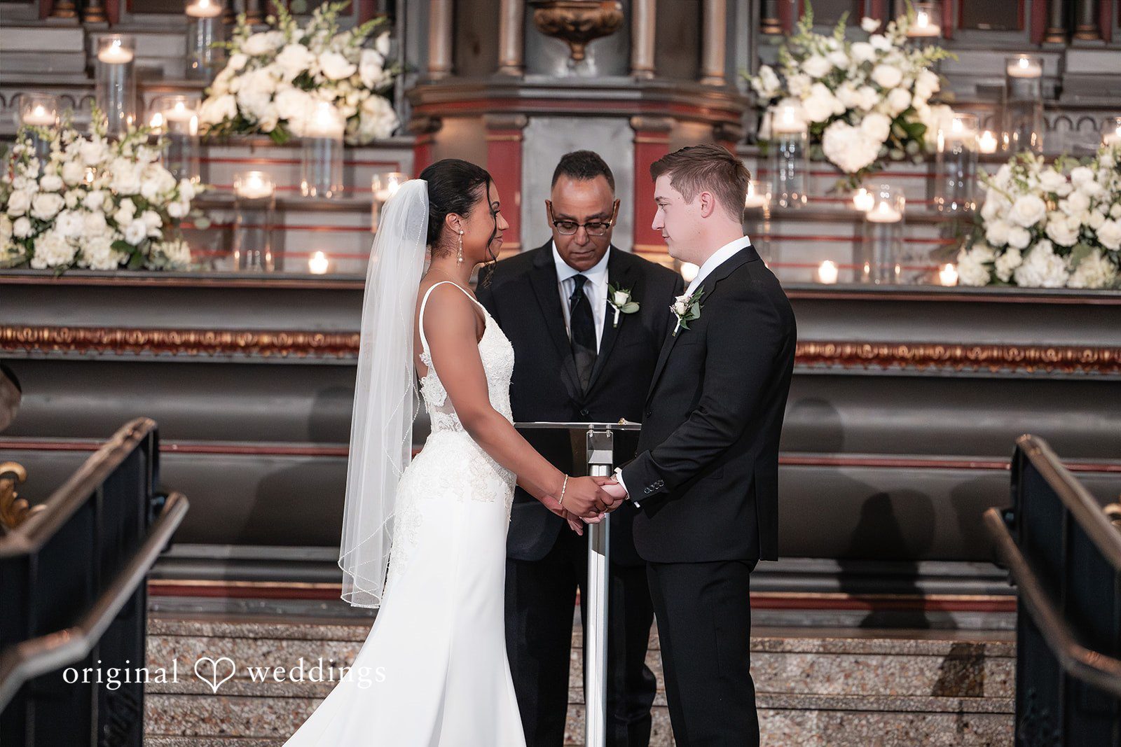 Sydney + Ty Close-up of the couple holding hands during the ceremony