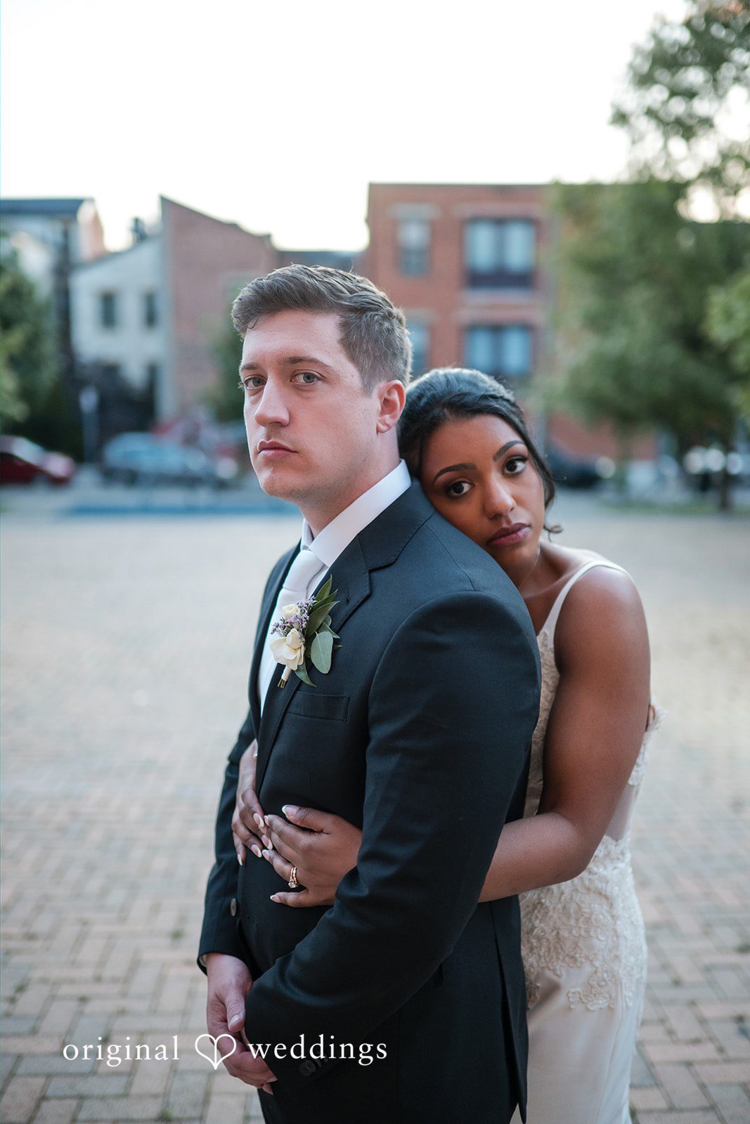 Sydney + Ty Bride embracing the groom from behind during portraits