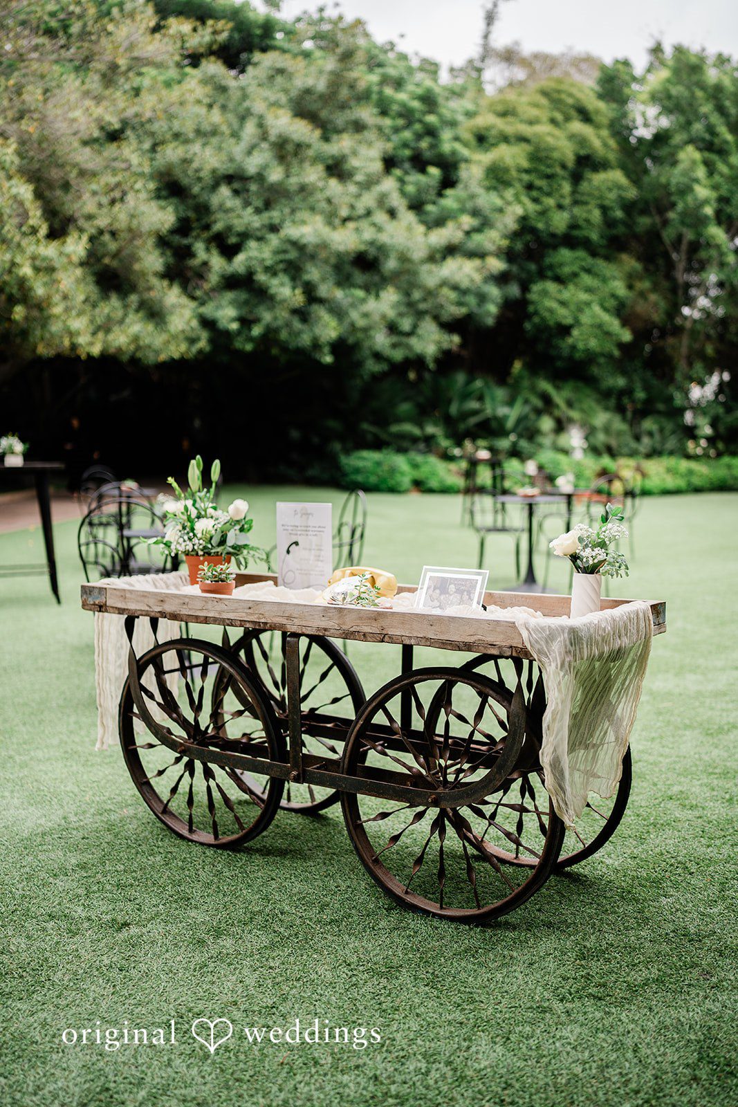 Mae + Nicholas Rustic décor cart with floral accents displayed on the reception lawn.
