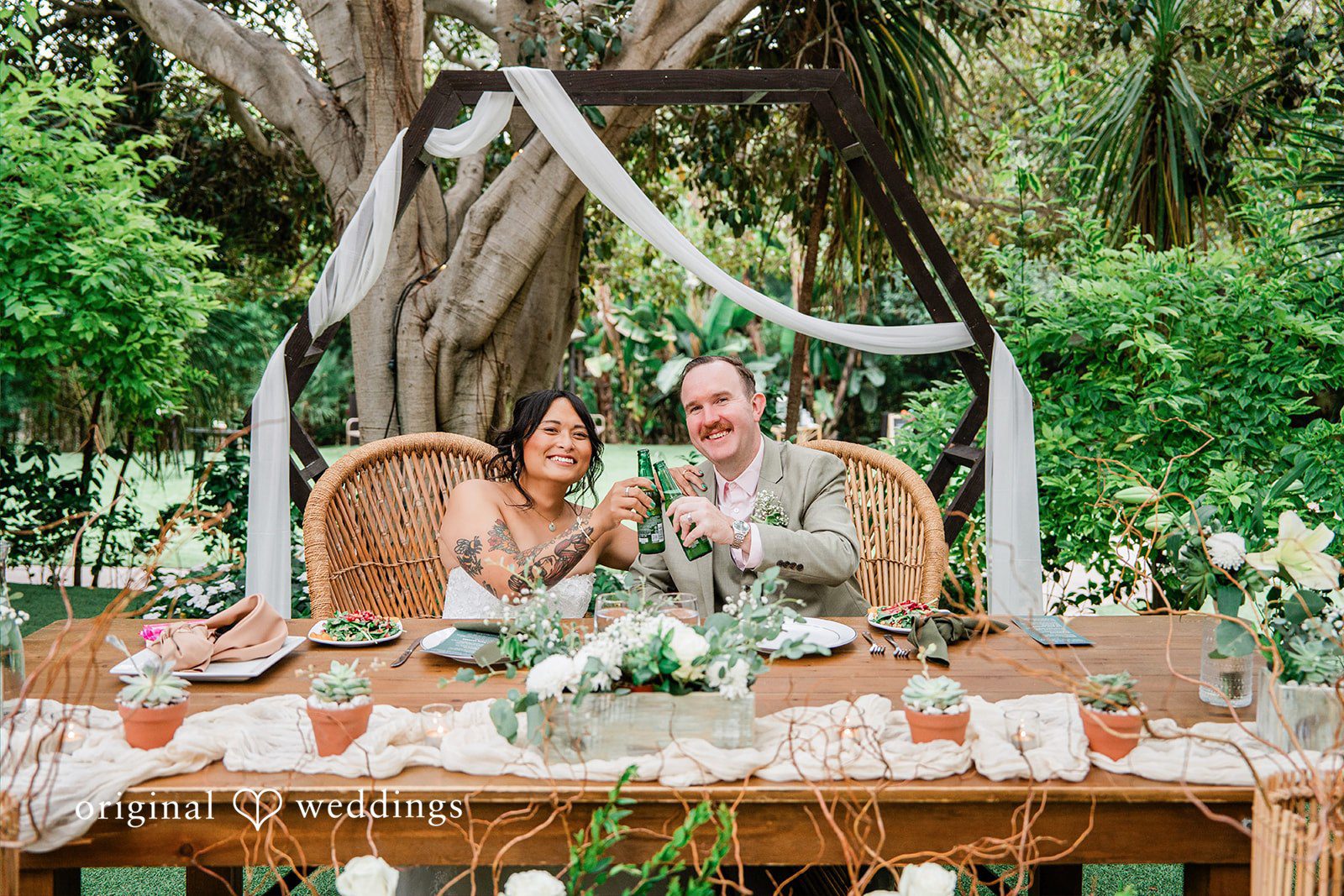 Mae + Nicholas Couple shares a celebratory toast at their beautifully styled reception table