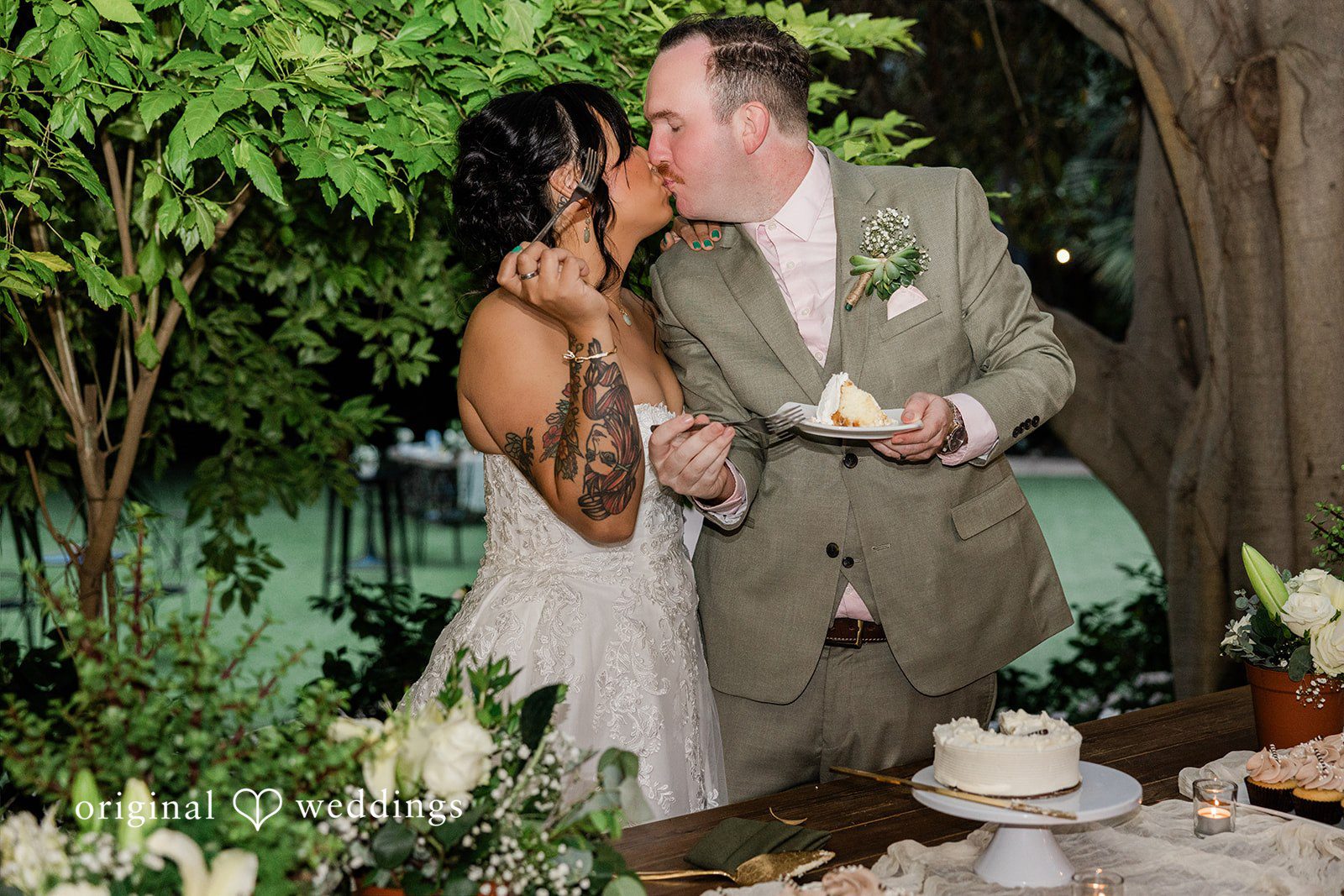 Mae + Nicholas Newlyweds share a sweet kiss while enjoying cake