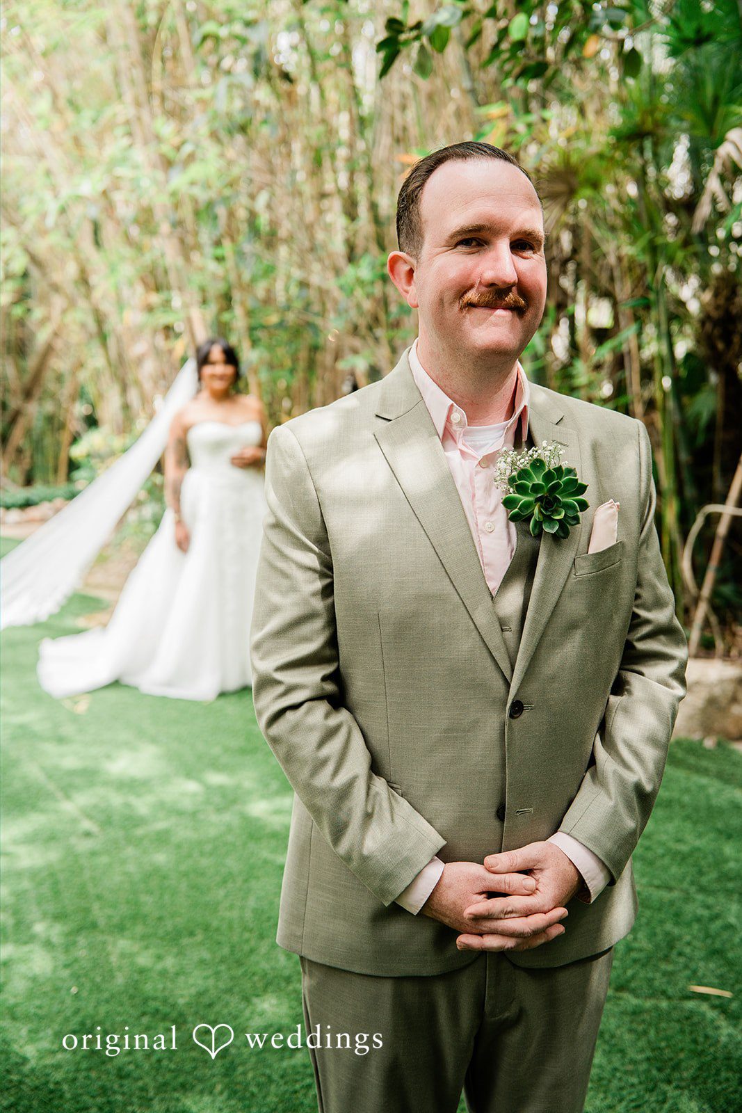 Mae + Nicholas Groom awaits the first look while the bride approaches through Botanica’s garden path.