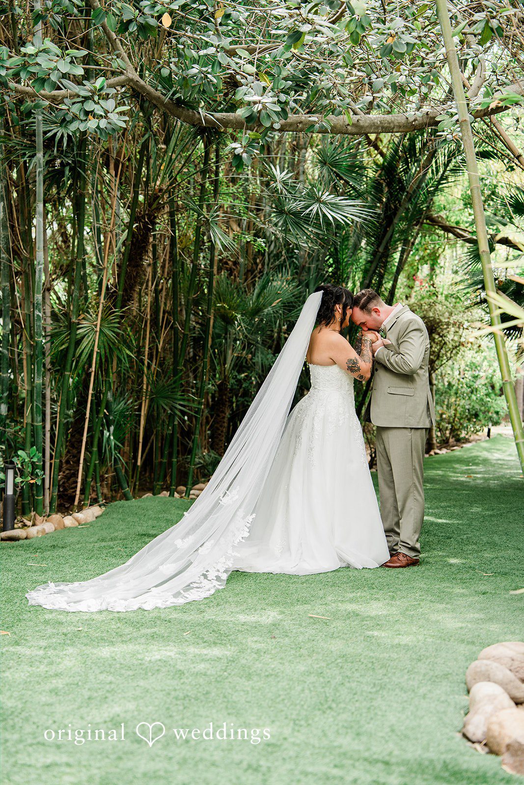 Mae + Nicholas Romantic portrait of the couple beneath Botanica’s lush bamboo canopy.