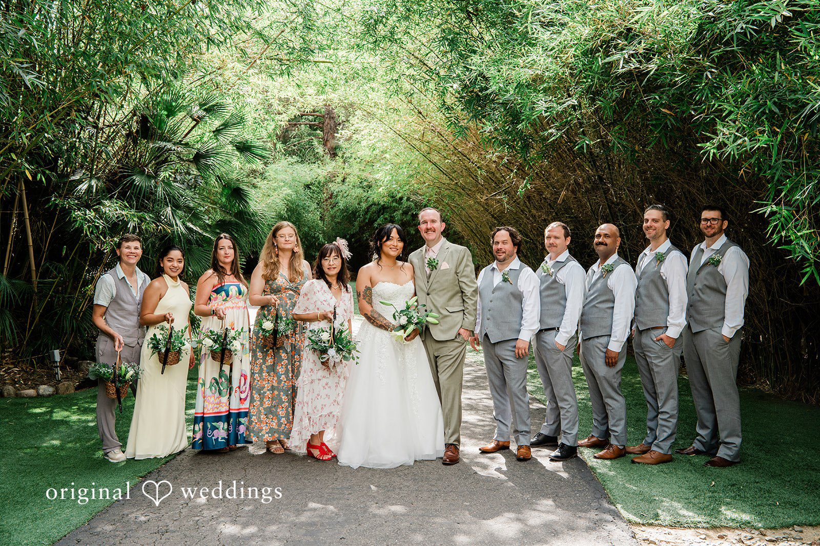 Mae + Nicholas Wedding party portrait framed by Botanica’s lush bamboo pathway.