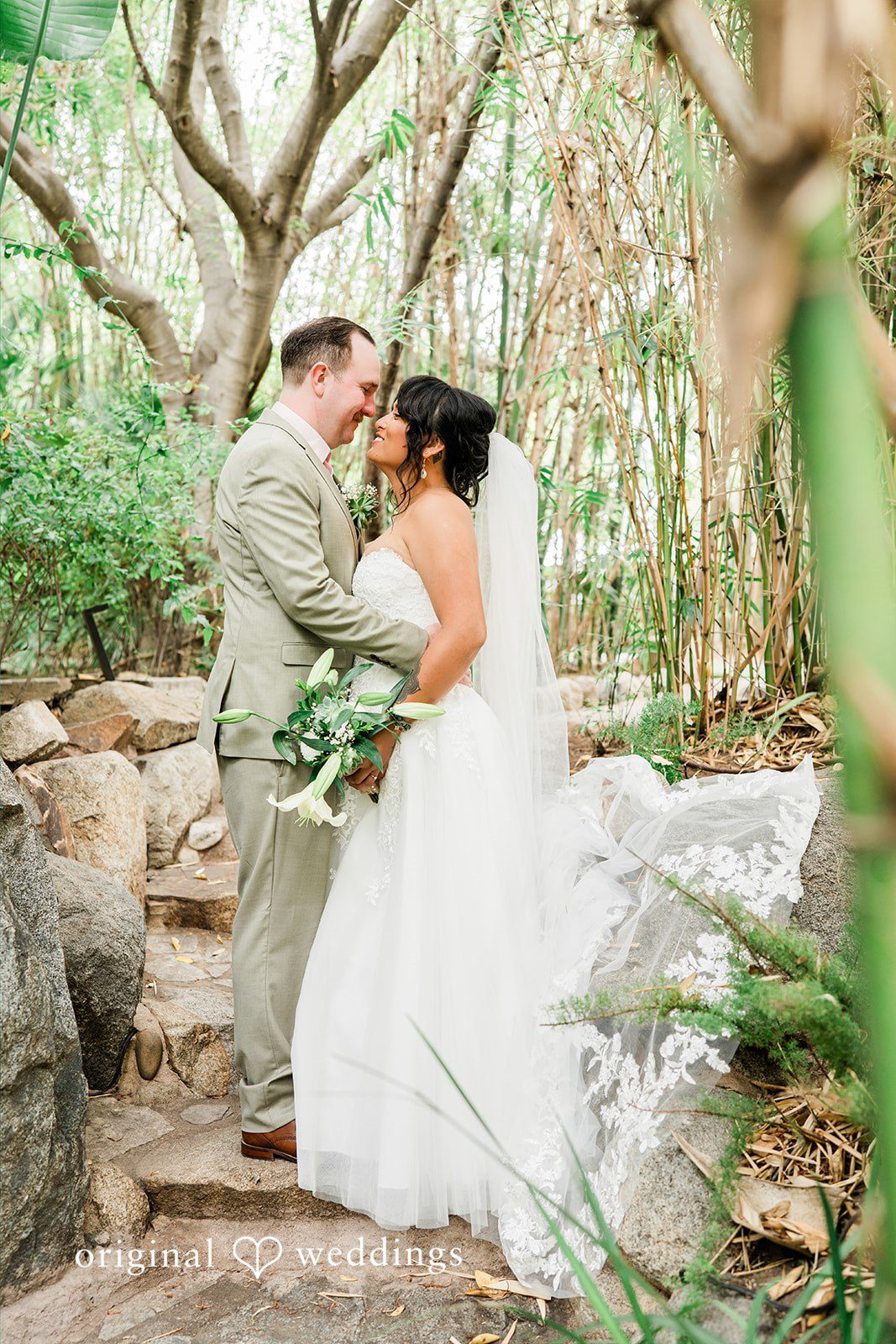 Mae + Nicholas Bride and groom sharing an intimate moment in Botanica’s lush bamboo garden.