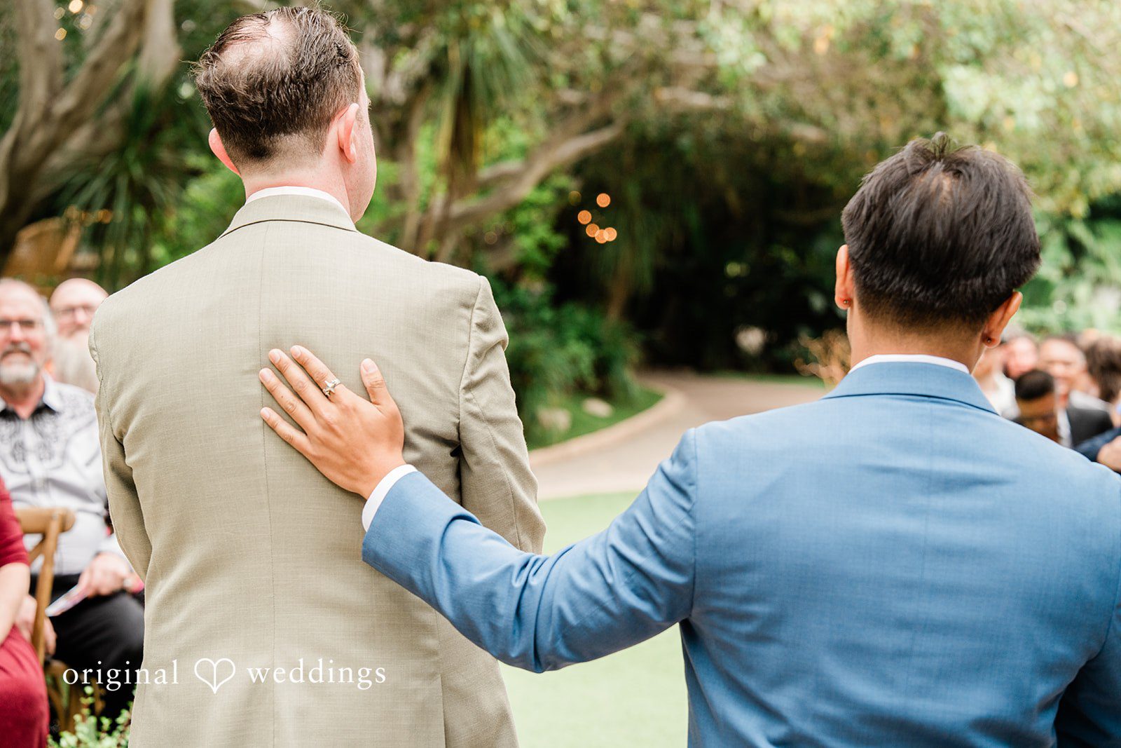Mae + Nicholas Groom receiving support from his best man before the ceremony at Botanica.