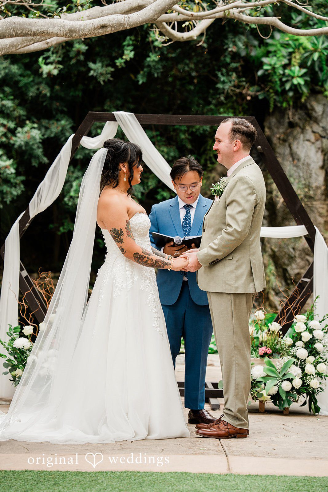 Mae + Nicholas Bride and groom holding hands during their intimate ceremony