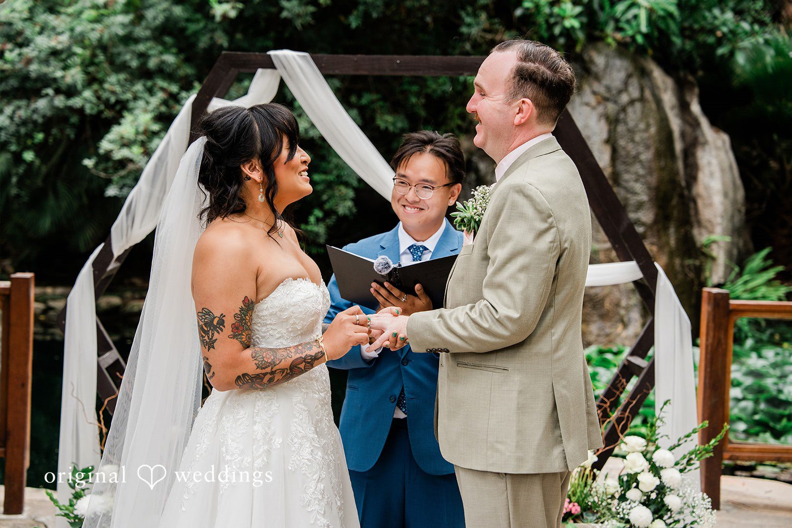 Mae + Nicholas Bride and groom exchanging vows under Botanica’s garden altar.