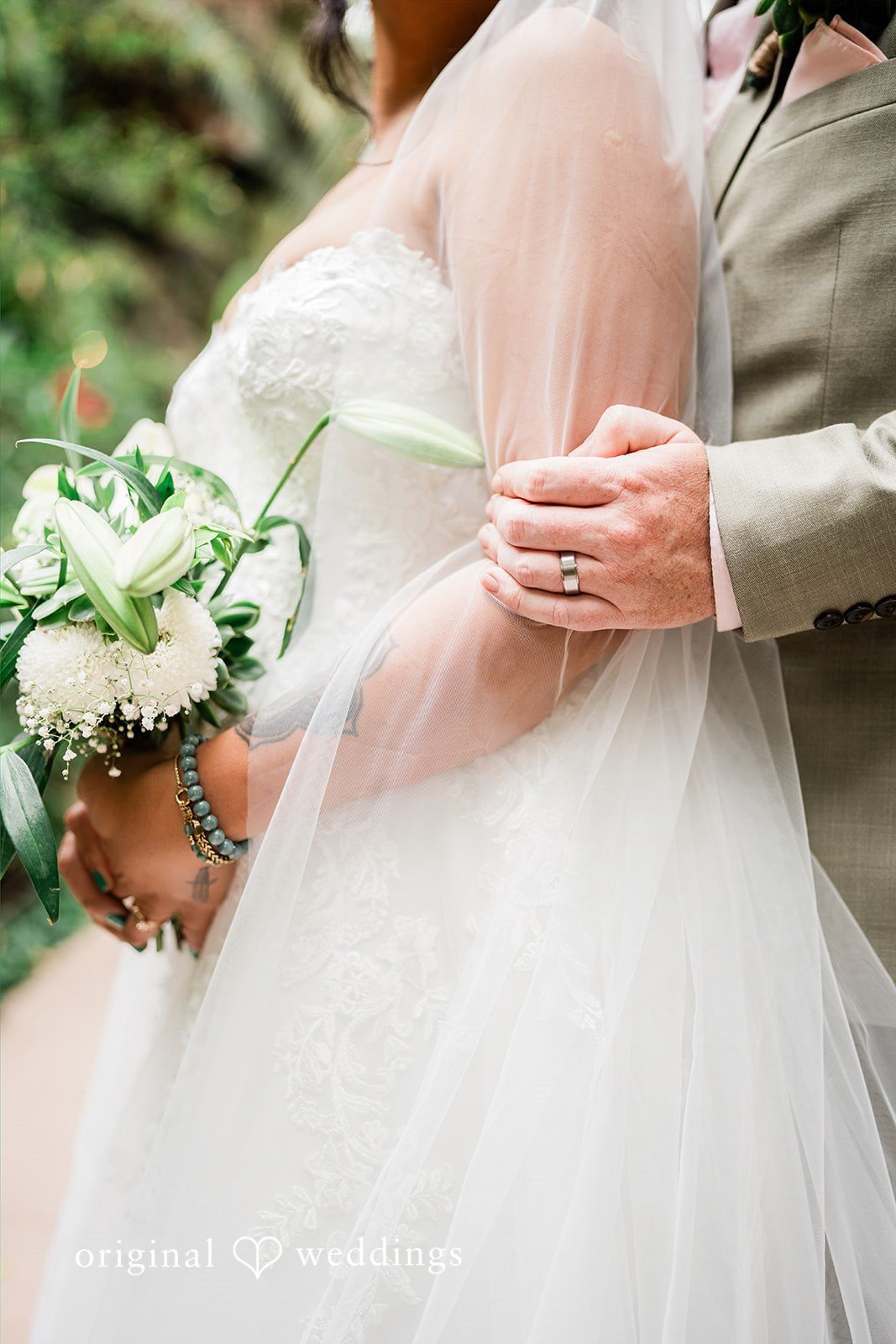 Mae + Nicholas Close-up of the couple’s hands and bouquet capturing intimate wedding details