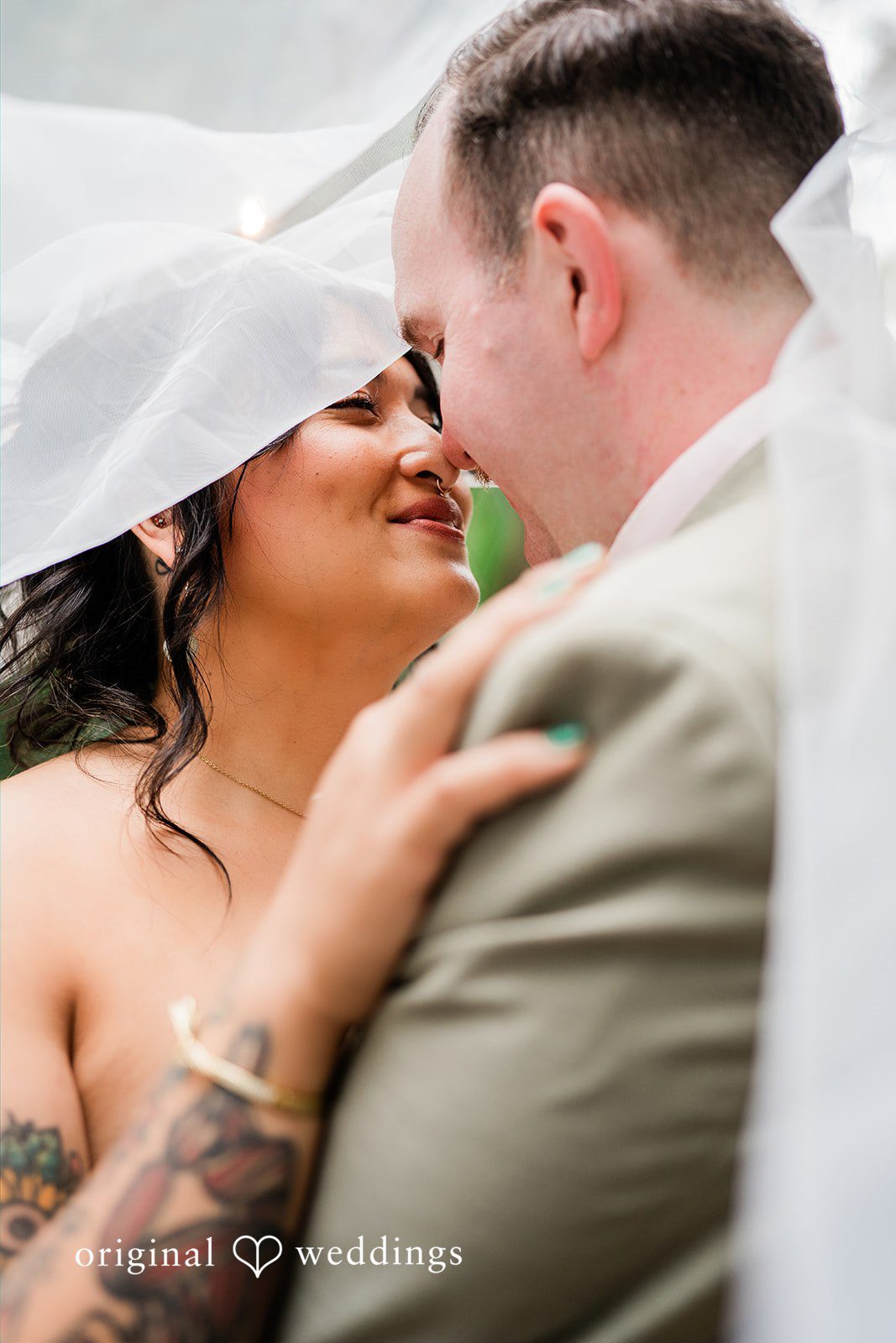 Mae + Nicholas Newlyweds sharing a romantic veil portrait