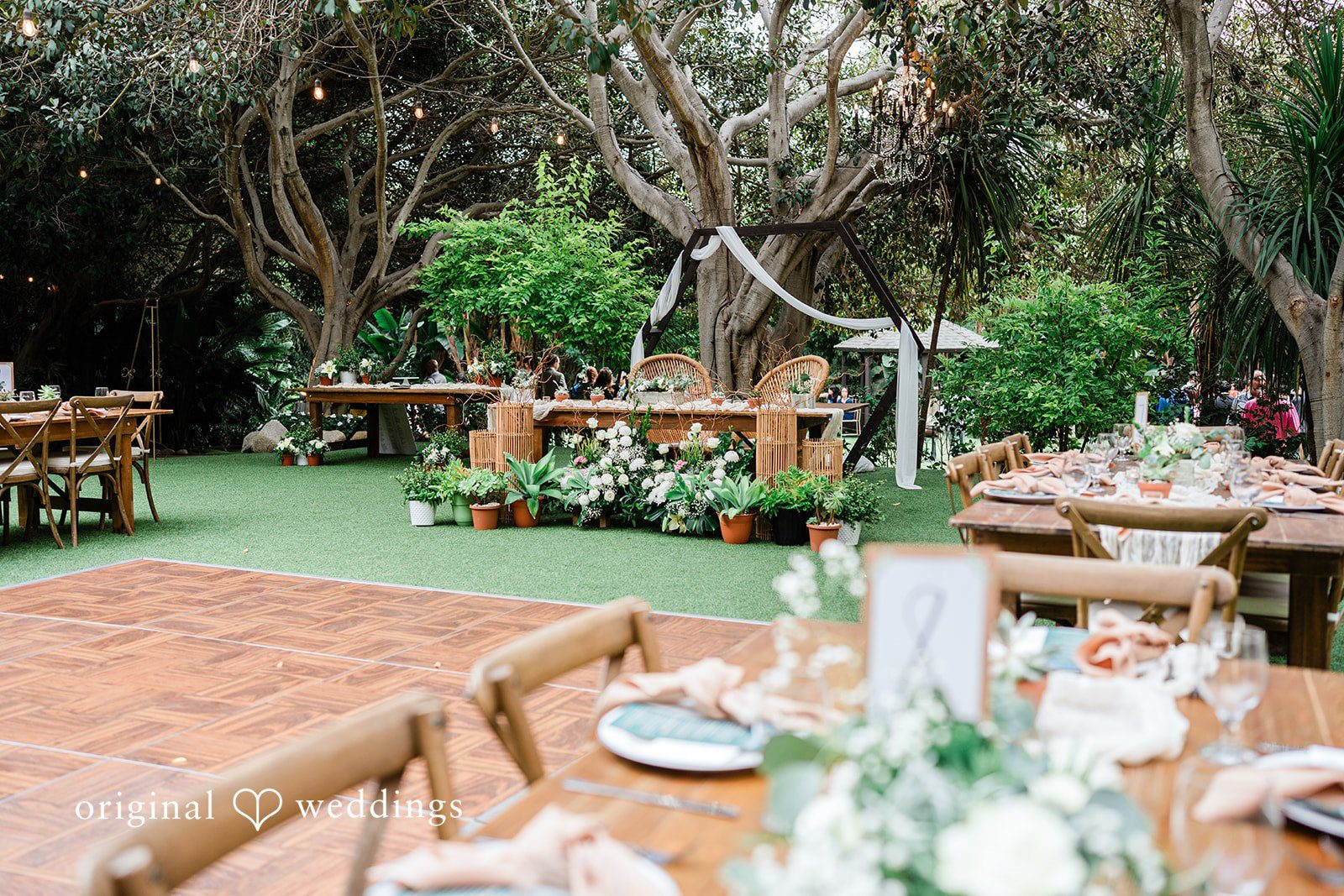 Mae + Nicholas Reception space featuring the decorated sweetheart table and dance floor at Botanica.