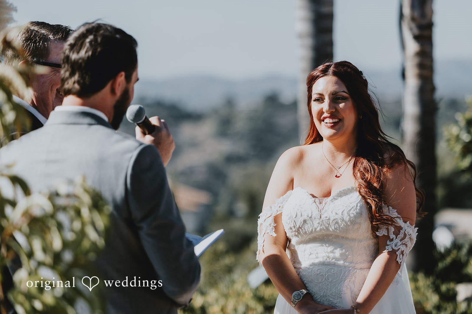 Groom reading his vows to bride during ceremony