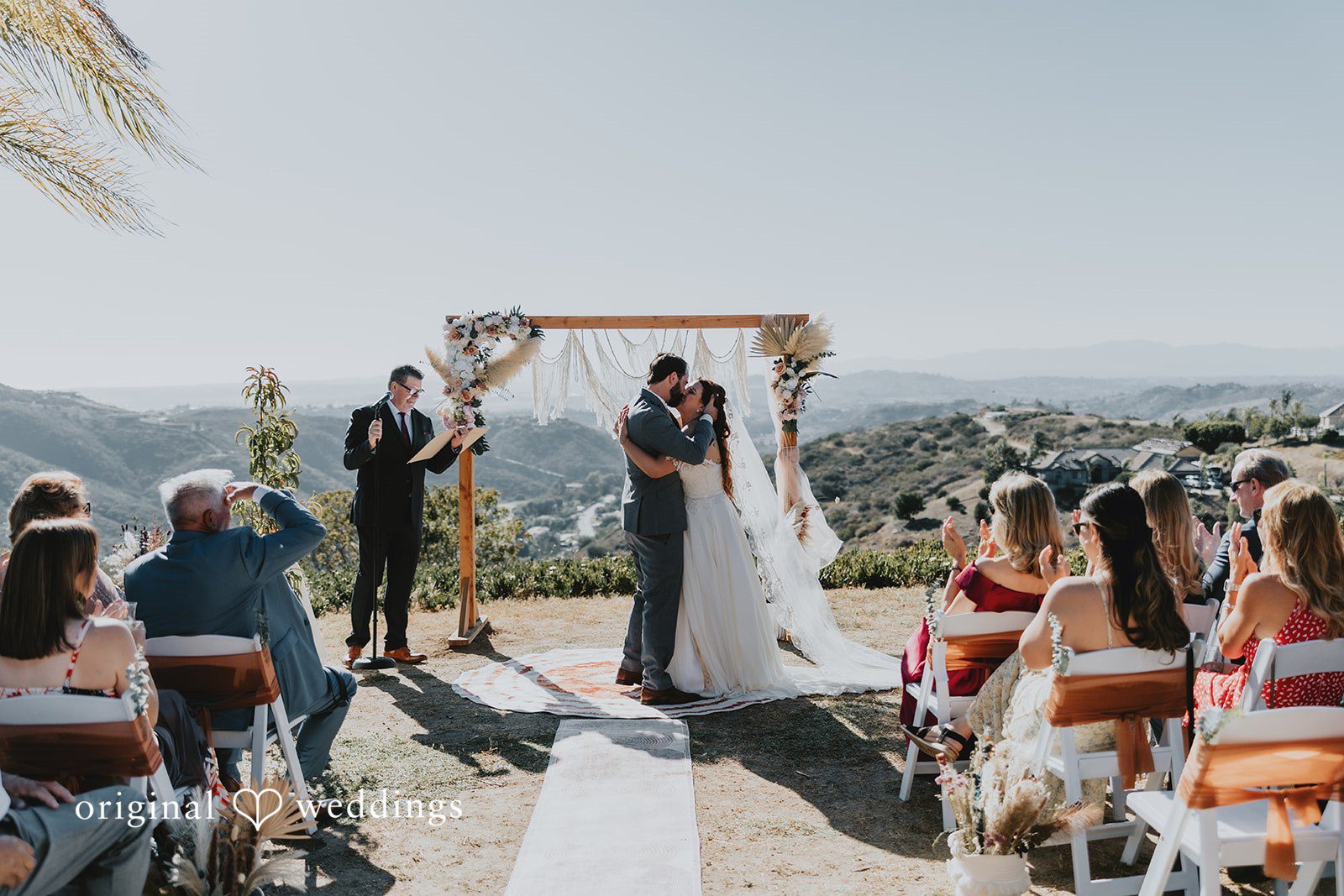 Romantic first kiss moment of the couple captured by San Diego Wedding Photographers