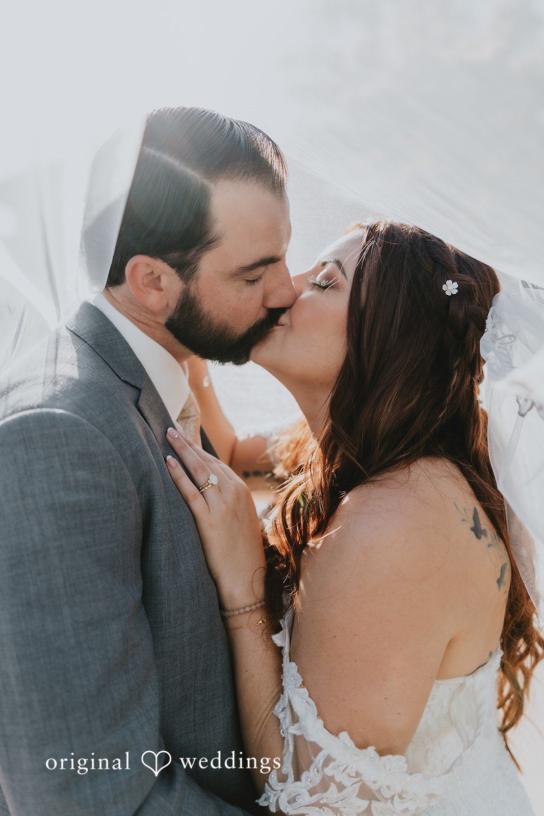 Lovely couple sharing a romantic kiss under the veil