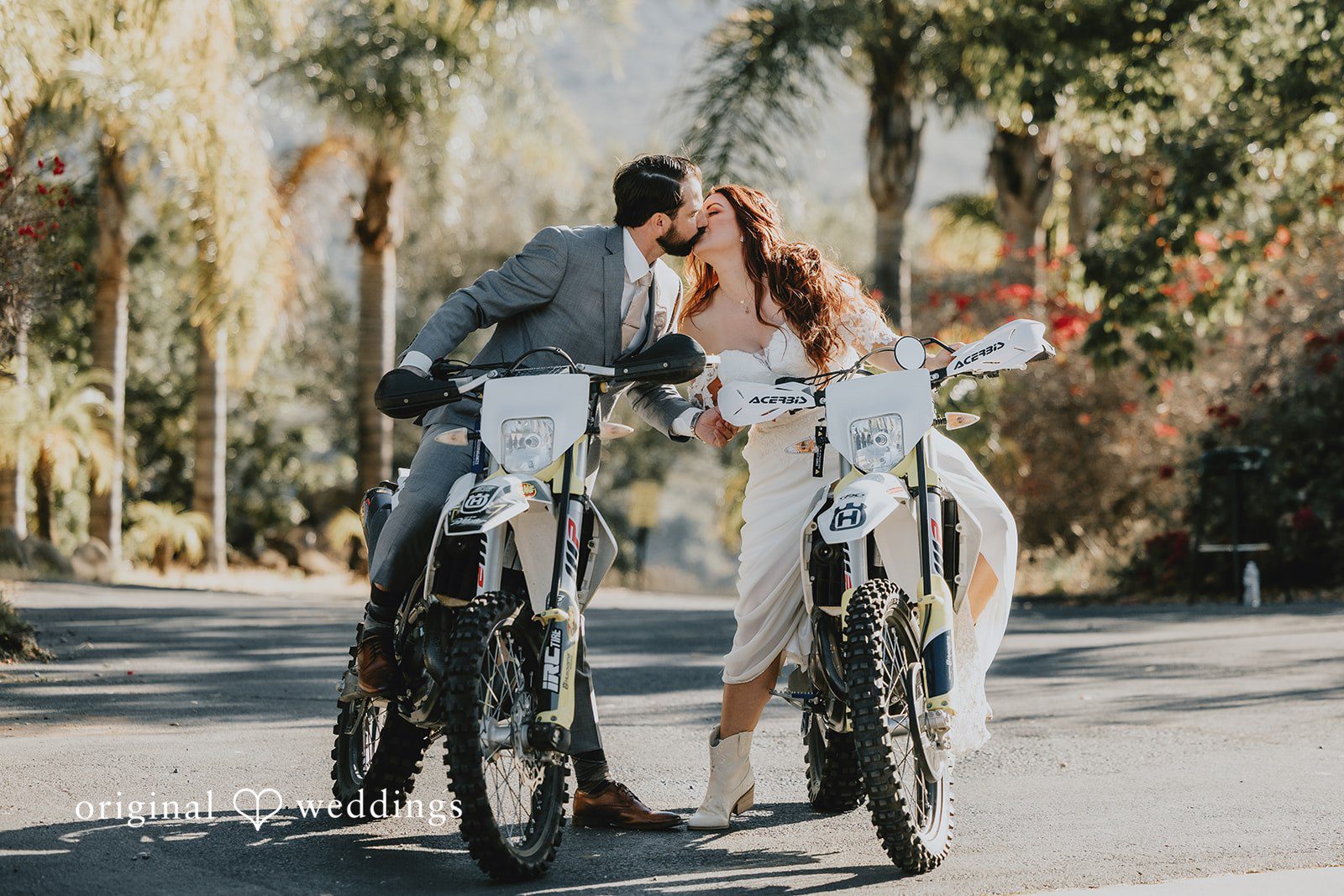 couple sharing a kiss while sitting on bikes