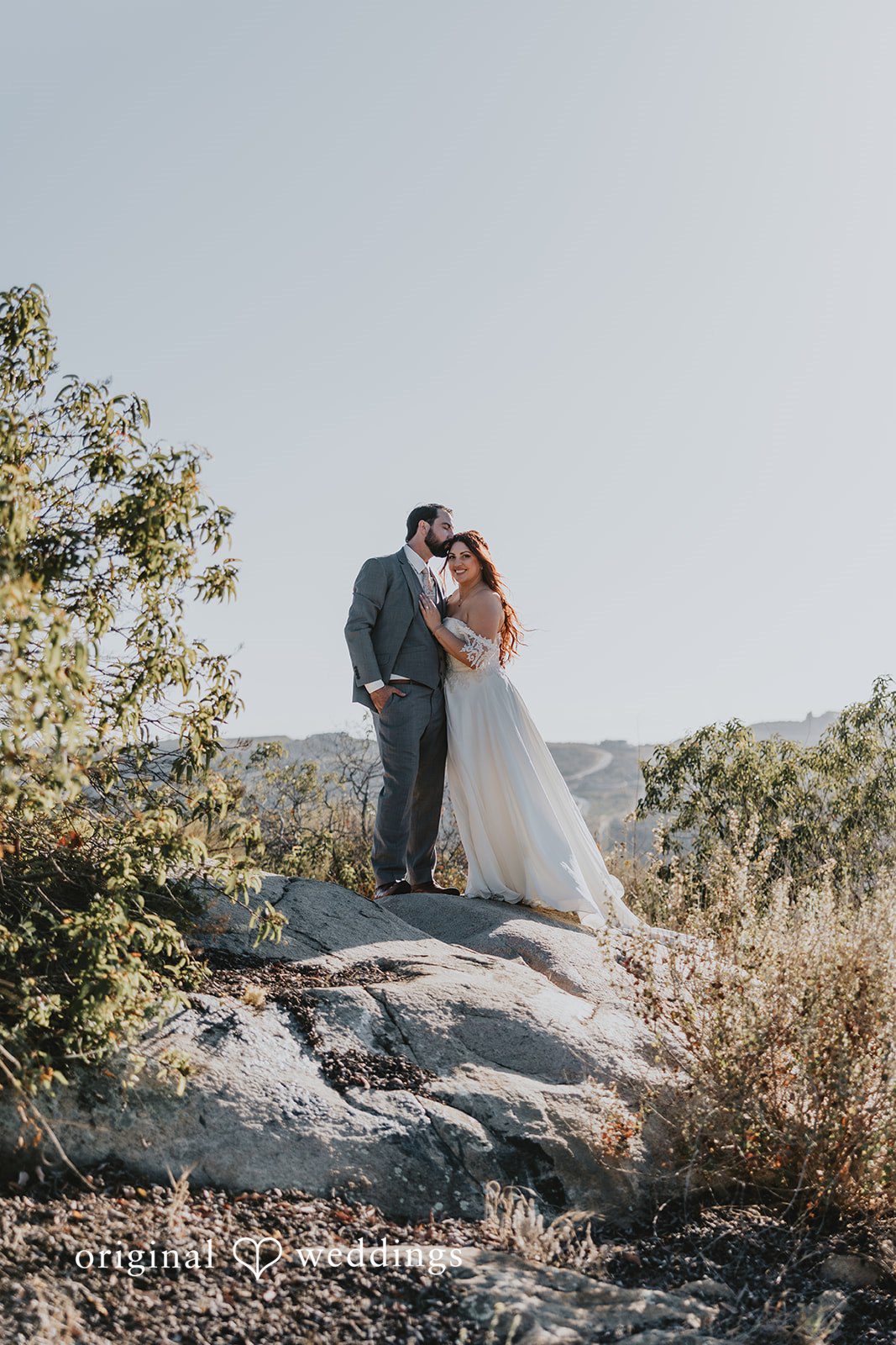 Lovely portrait of couple standing at a rock