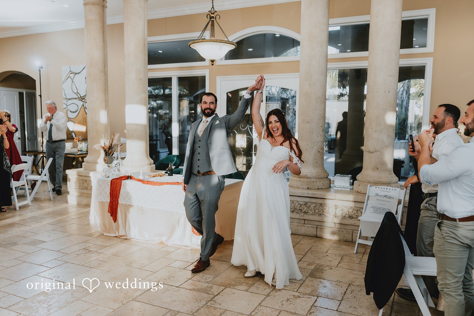 Couple entering the reception hall happily