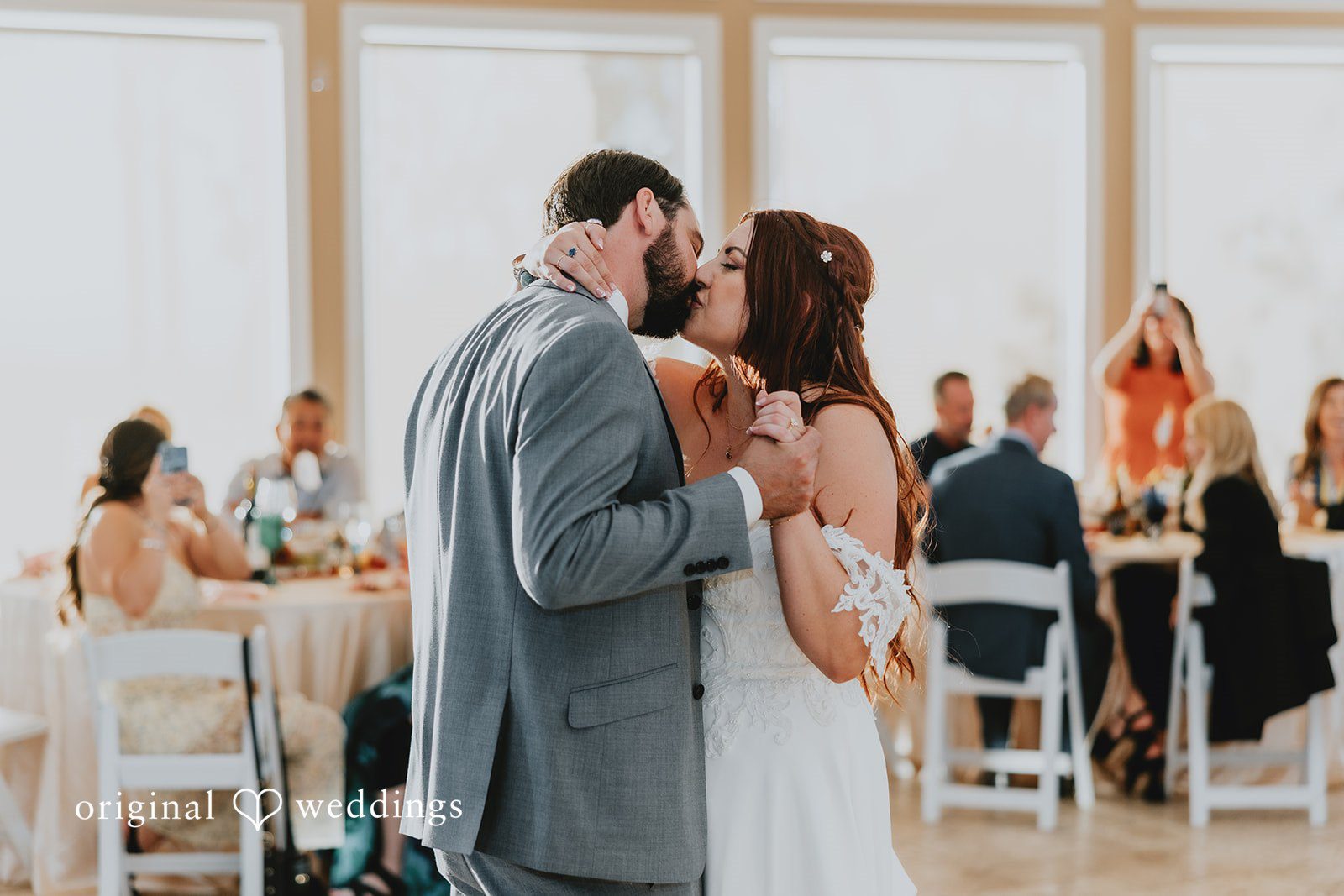 Bride and groom sharing a romantic kiss while dancing