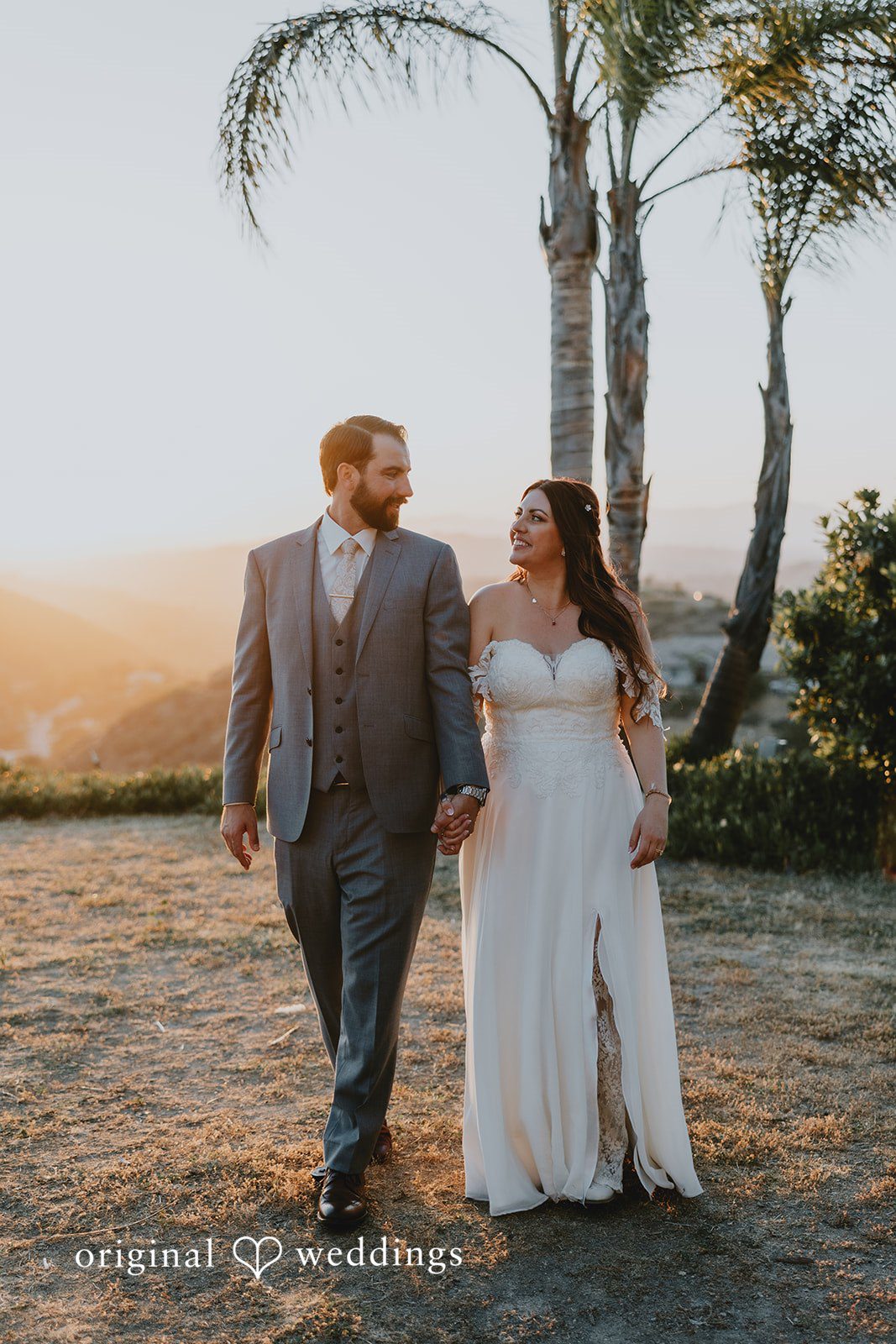 Beautiful couple walking hands in hands and looking at each other